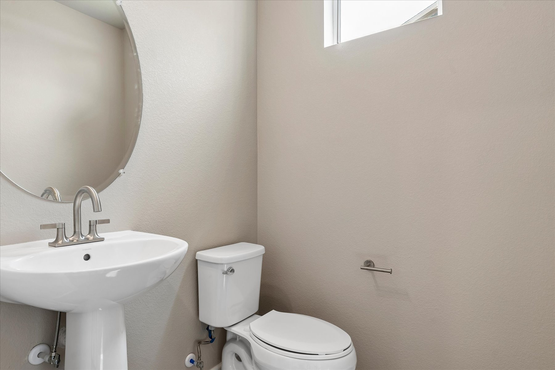 A bathroom with a sink and toilet.