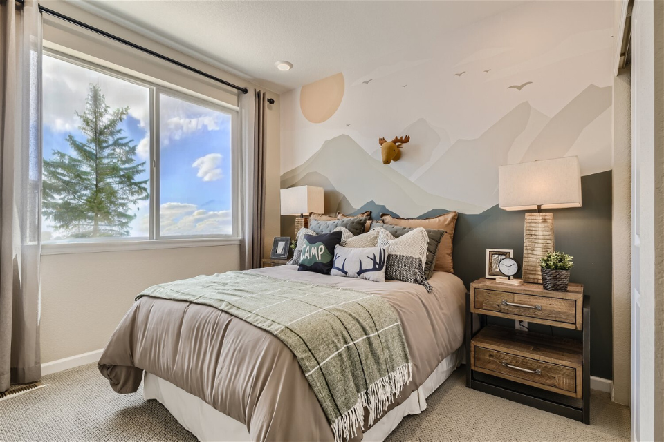 A bedroom with a bed and a window.