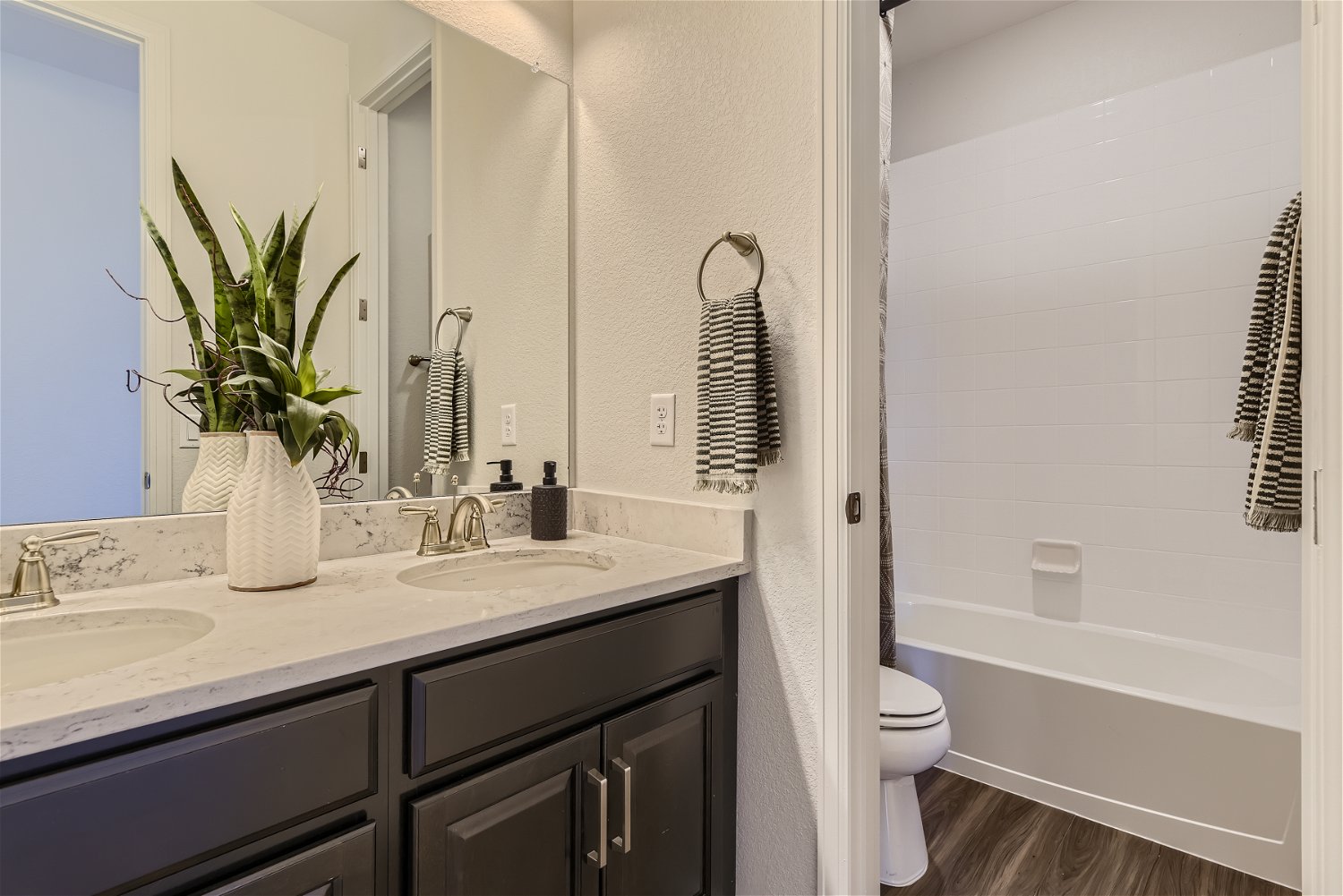 A bathroom with a sink toilet and a bathtub.