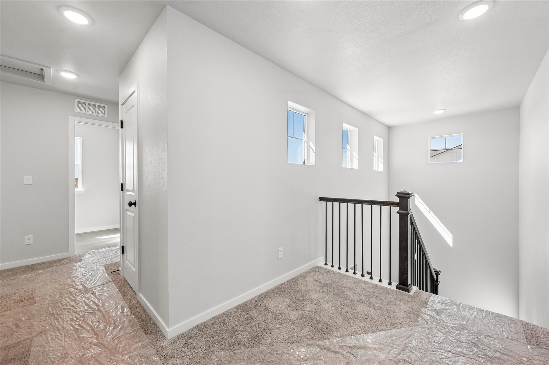 A hallway with white walls.