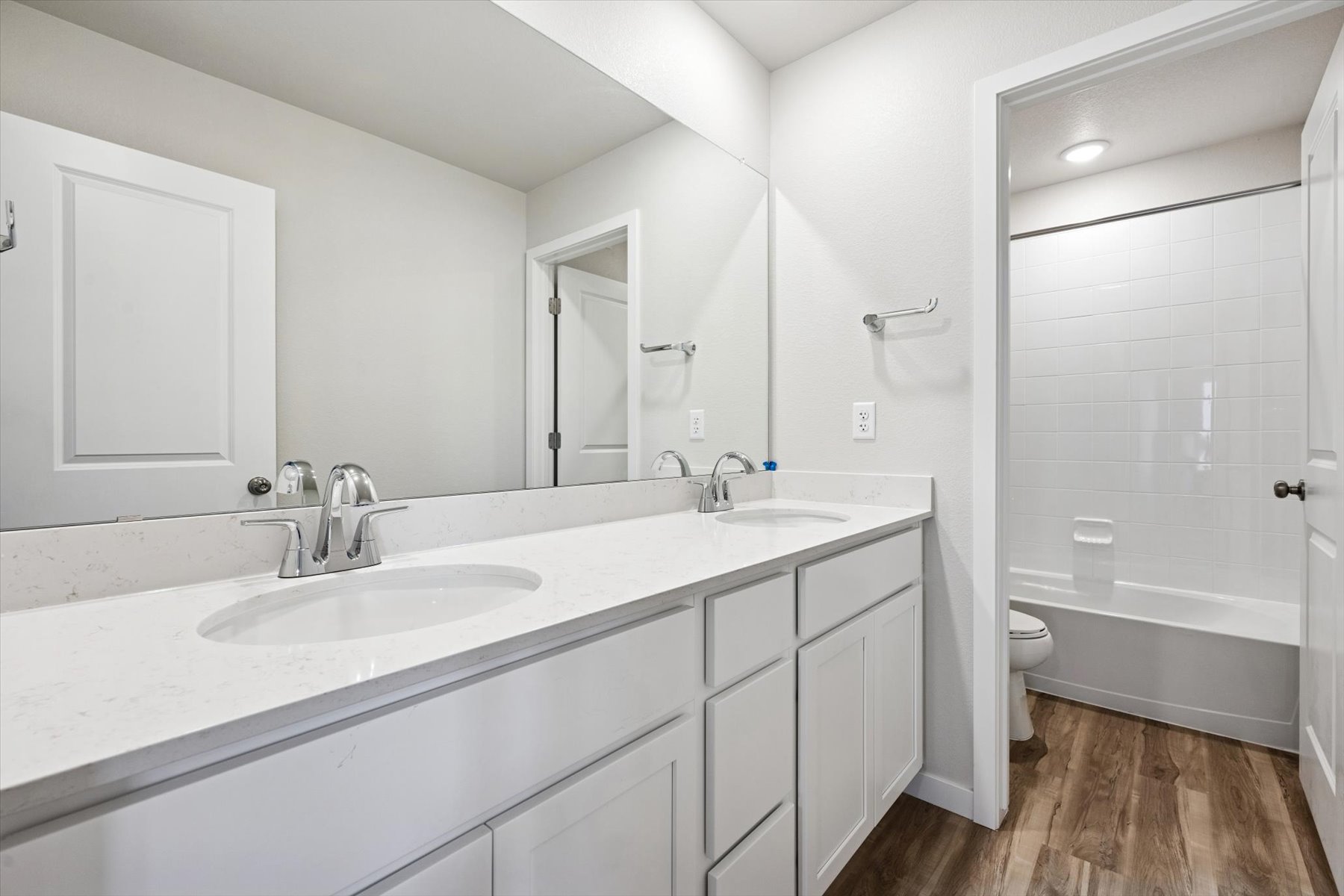 A bathroom with a tub sink and toilet.