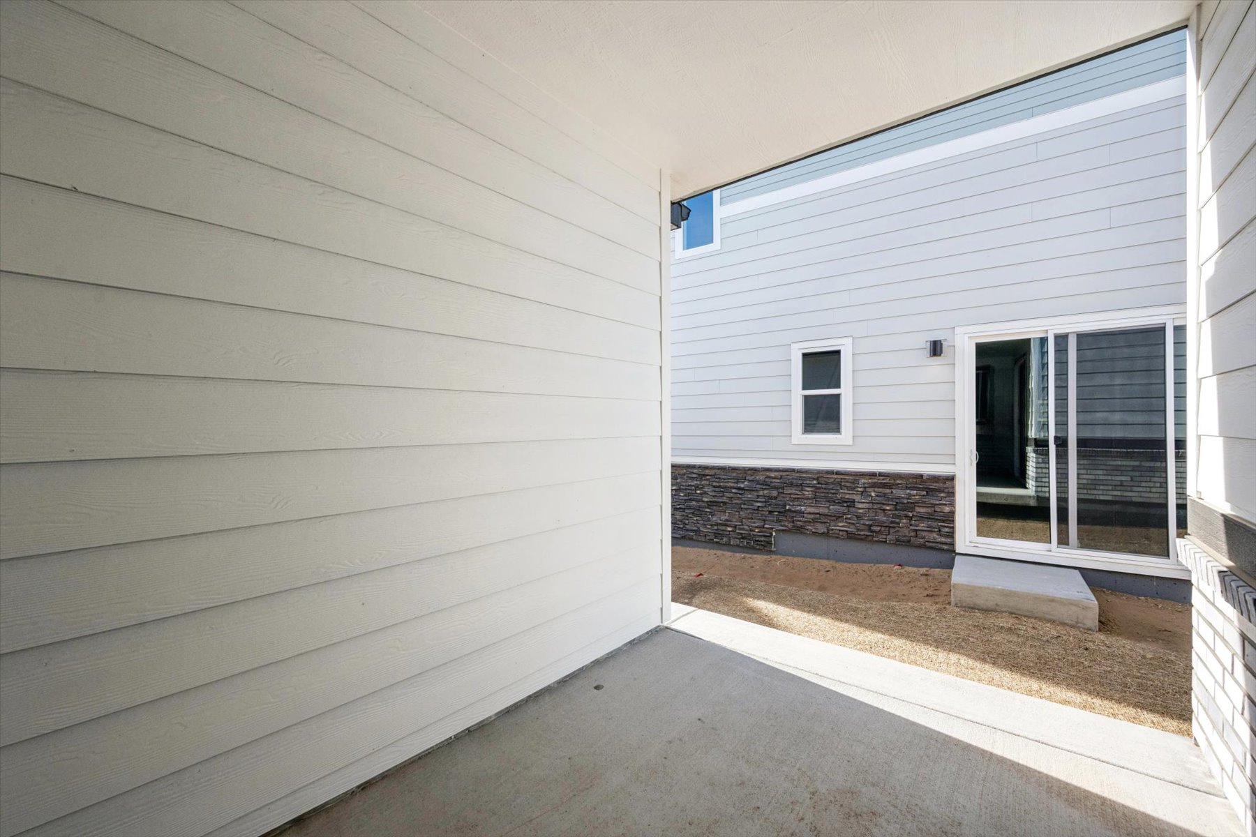 A white building with a garage.