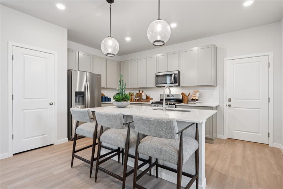 A kitchen with white cabinets.