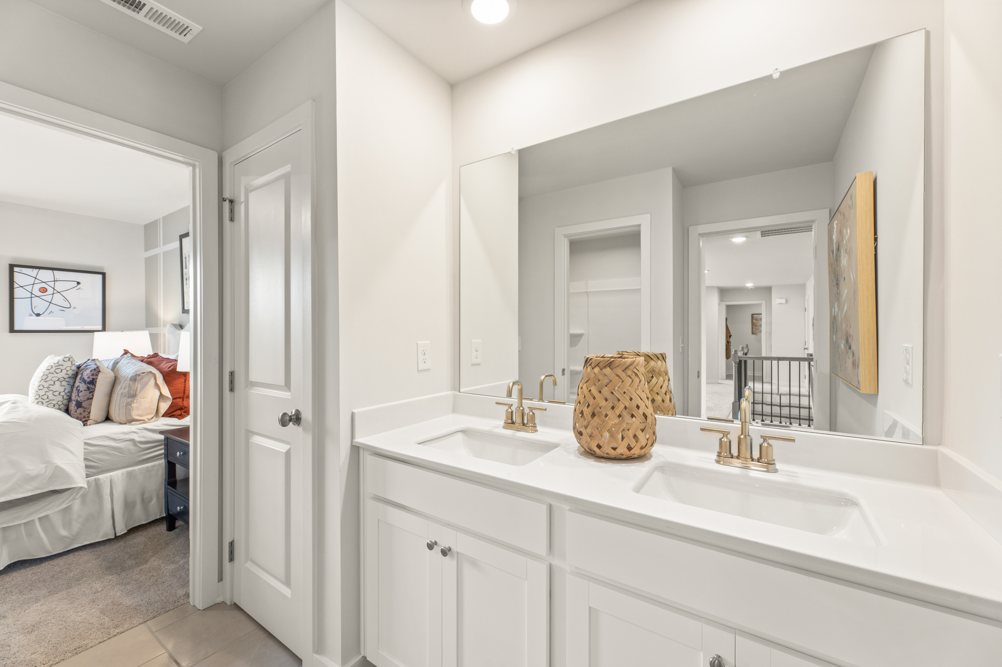 A bathroom with a bed and sink.