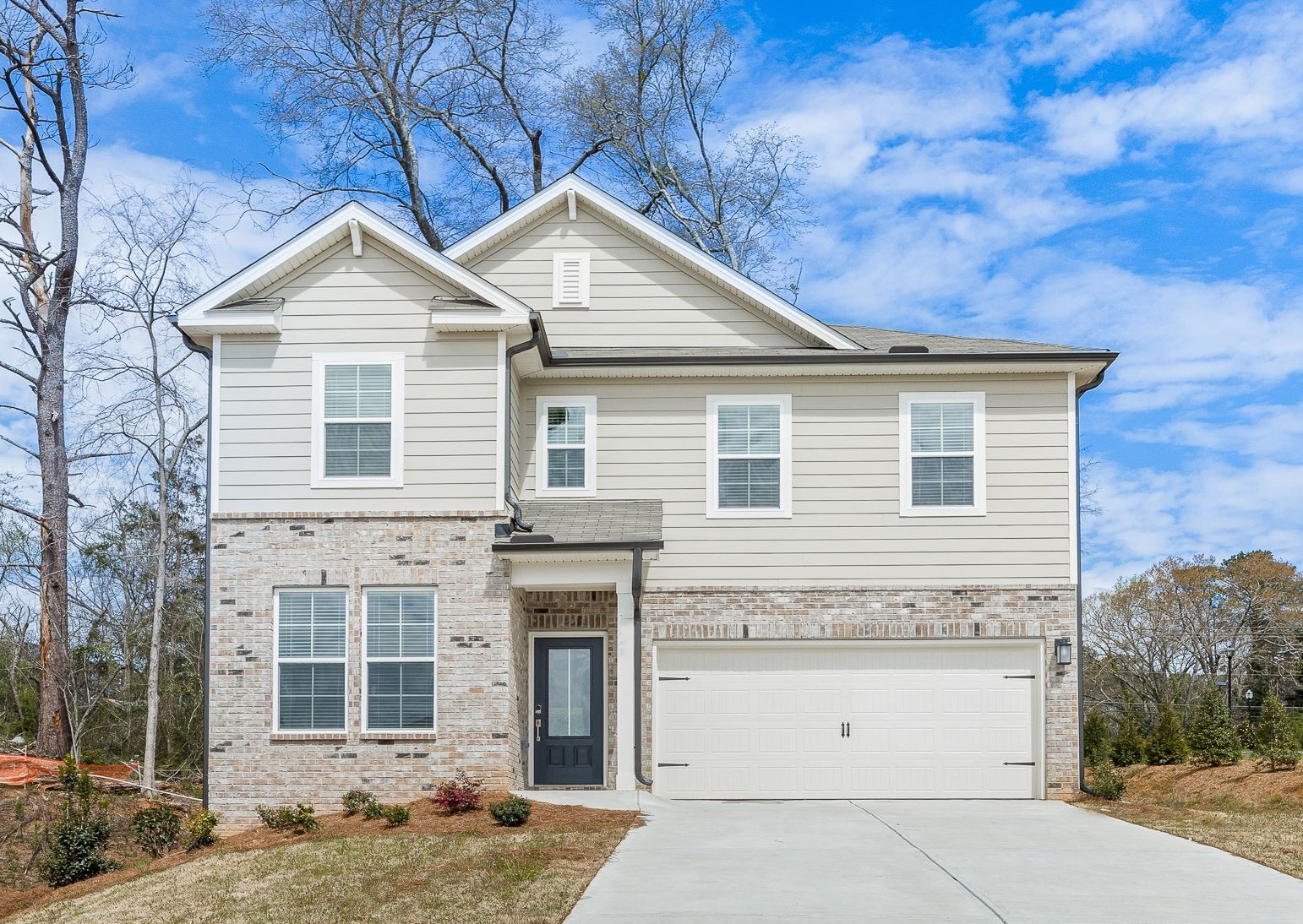 A white house with a garage.