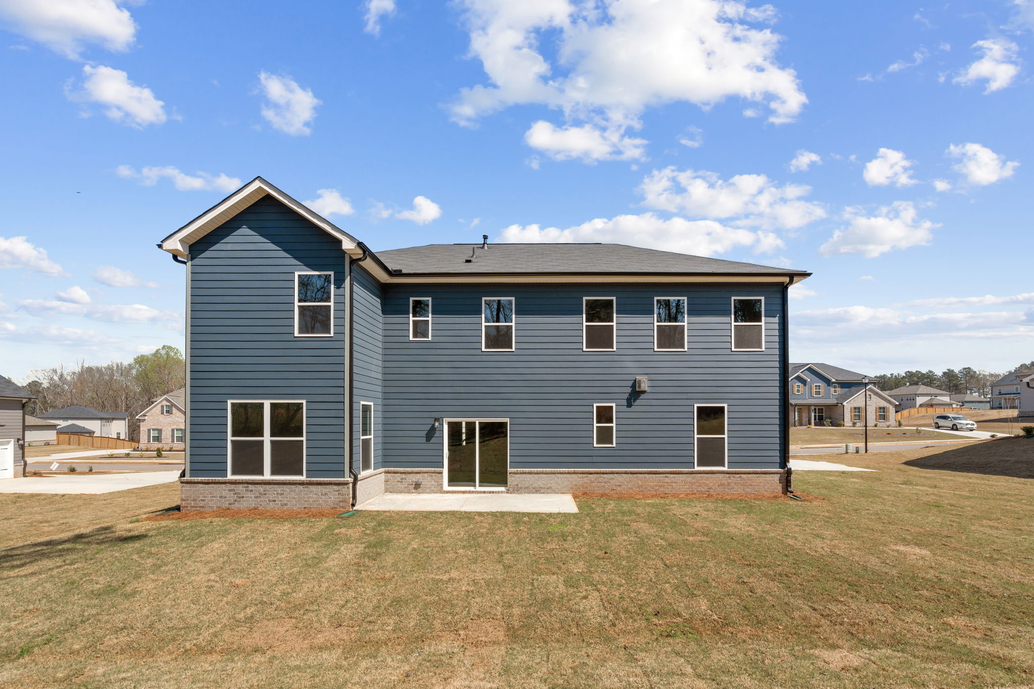 A blue house with a grass yard.