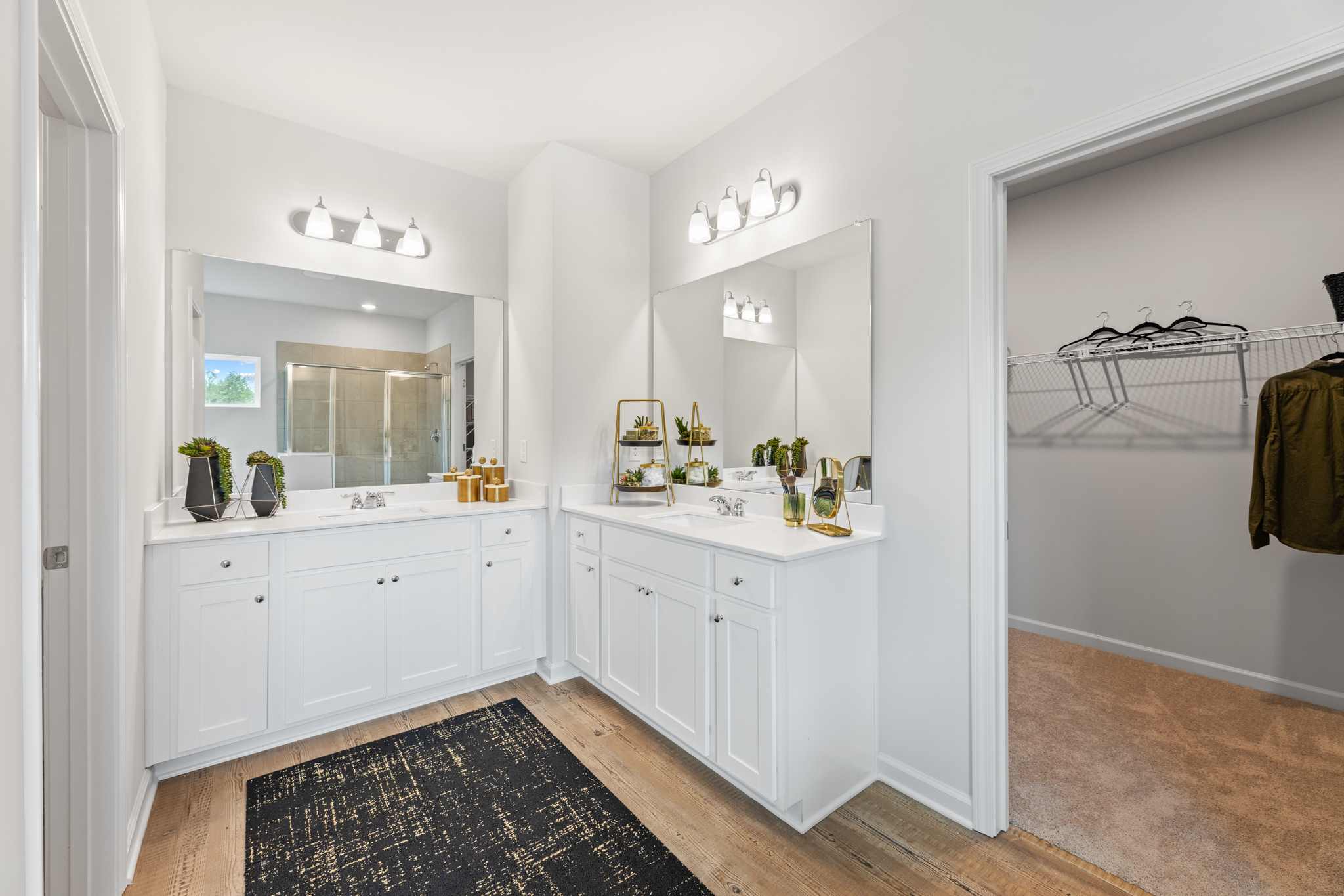 A bathroom with white cabinets.