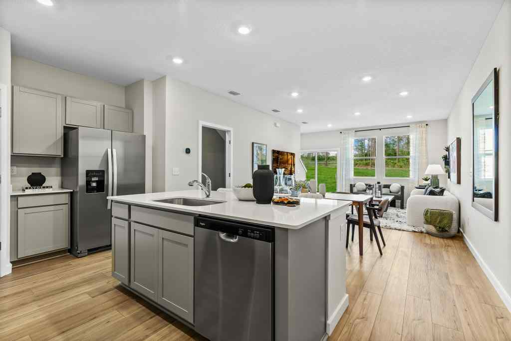 A kitchen with a wood floor.