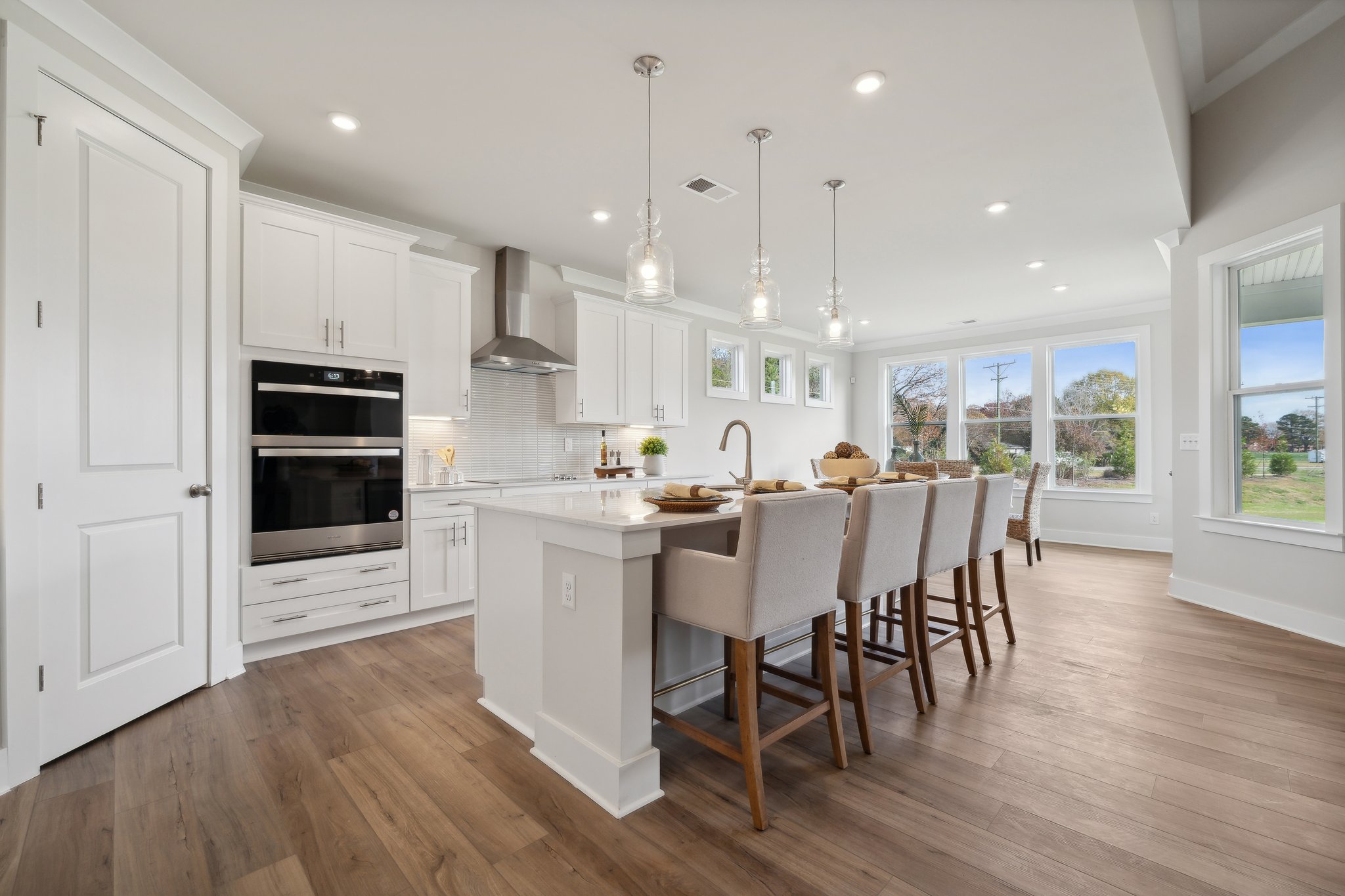 A kitchen with a dining table and chairs.
