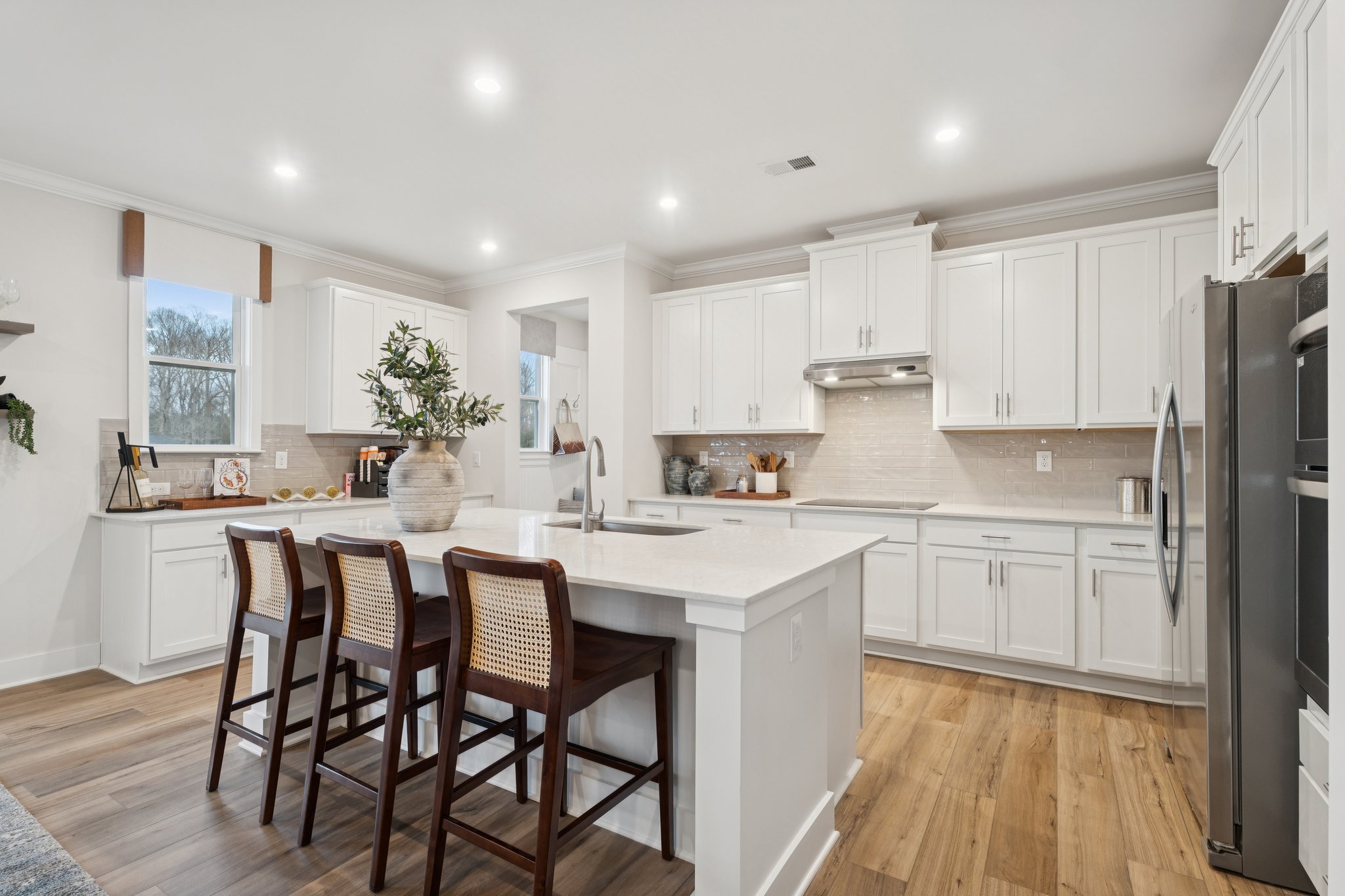A kitchen with white cabinets.