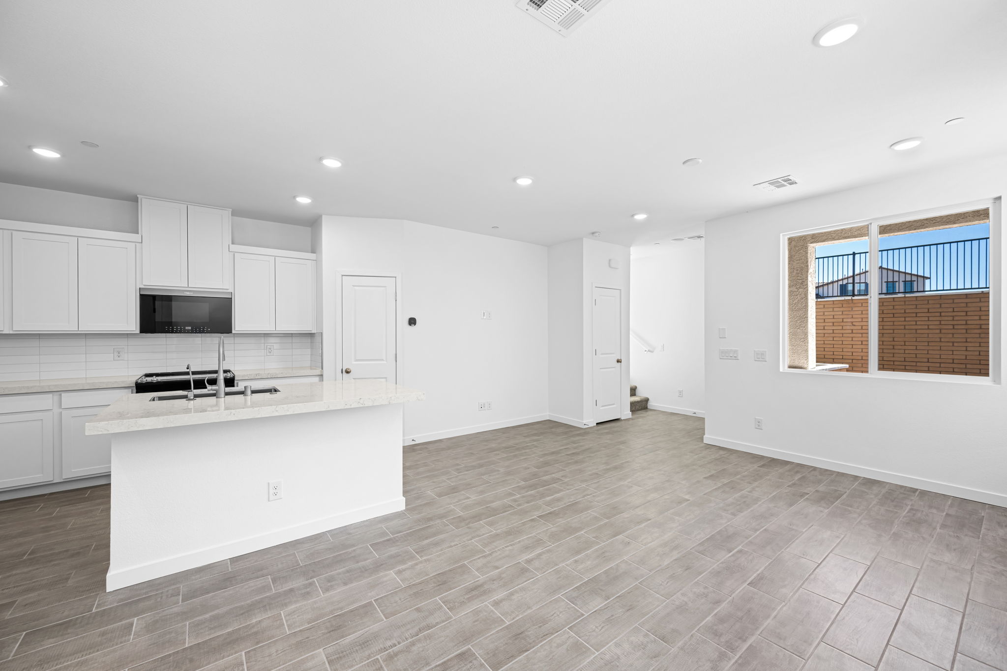 A kitchen with white cabinets.