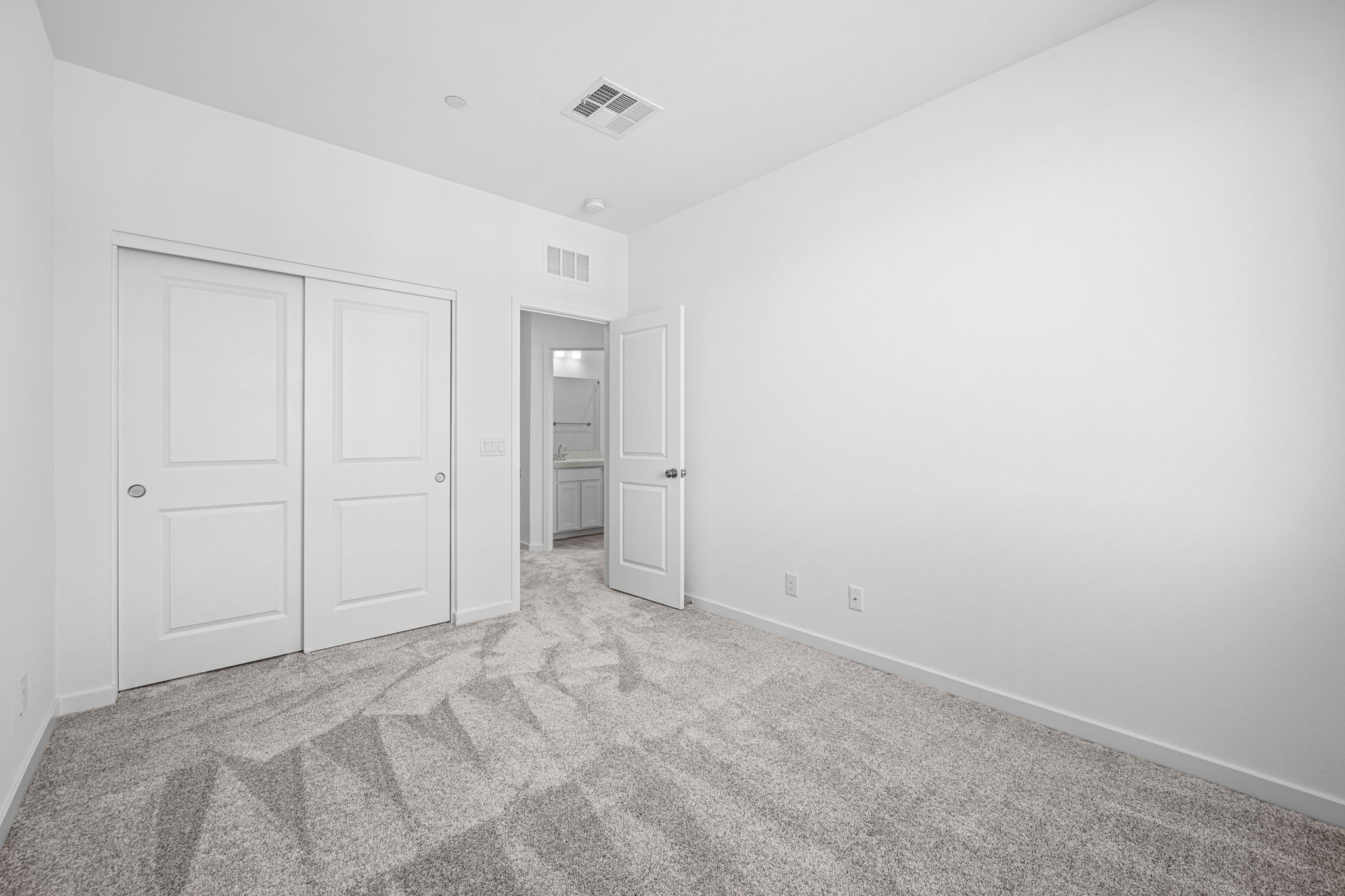 A hallway with white doors.