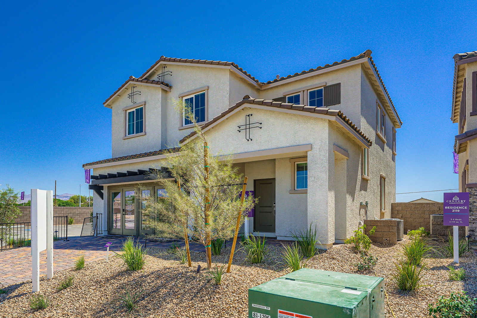 A white building with a cross on top.