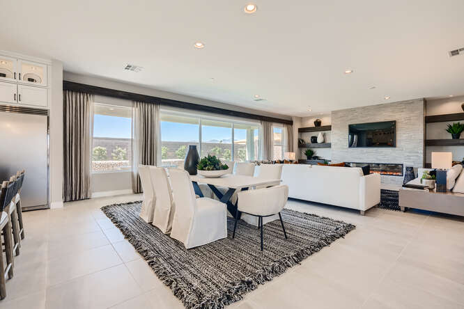 A large living room with a large table and chairs.