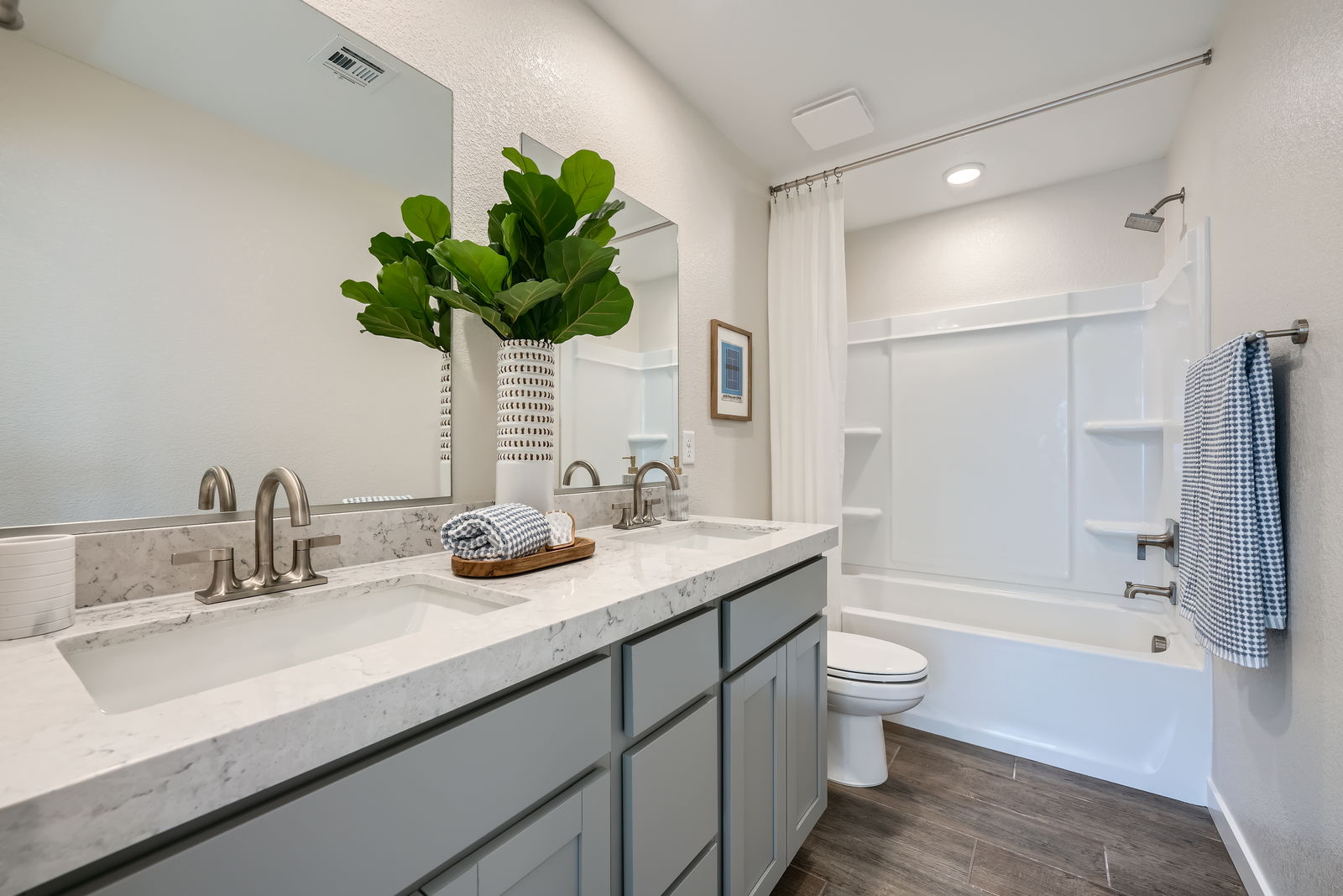 A bathroom with a tub sink and toilet.