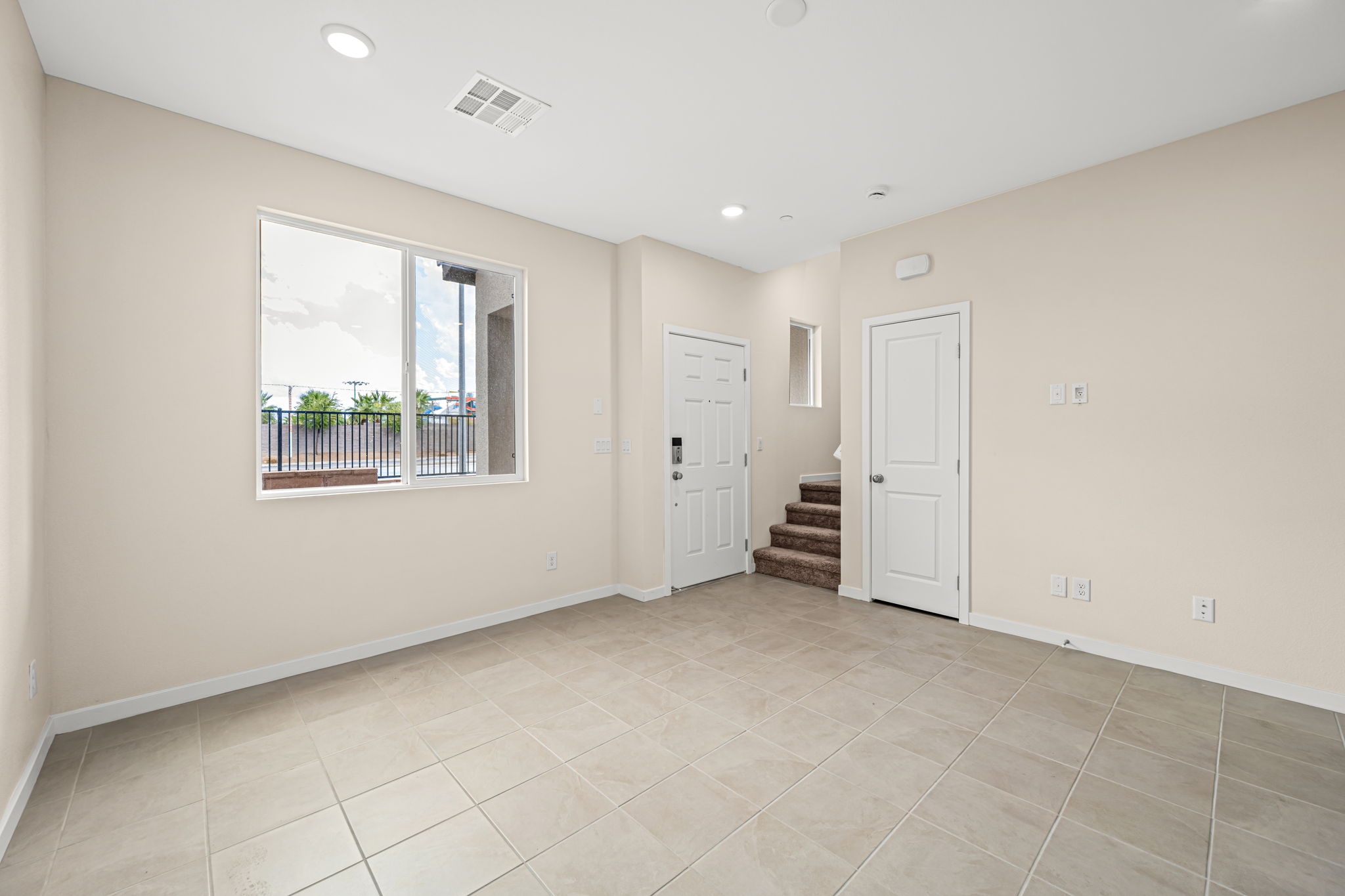 A room with a window and a door.