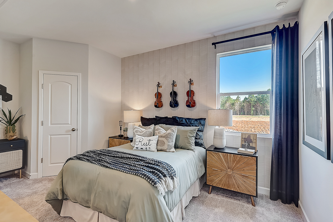 A bedroom with a large window.