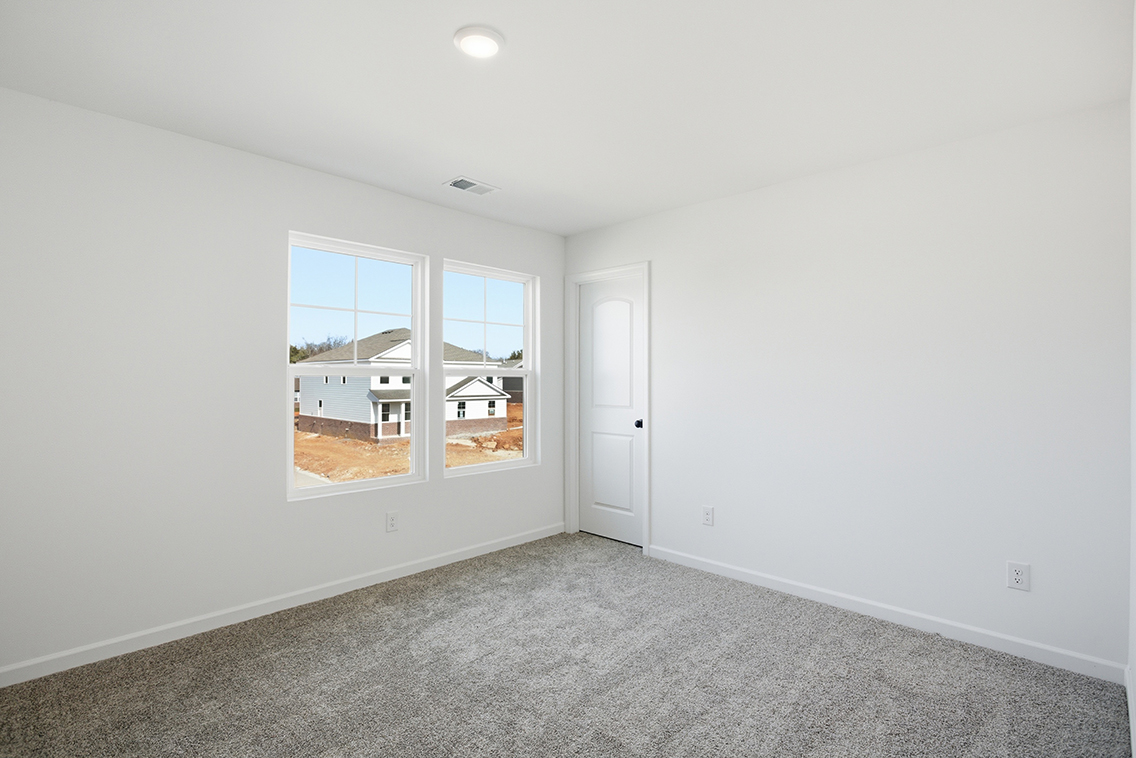 A room with a window and a door.