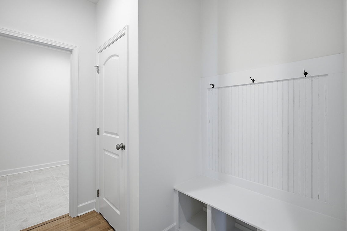 A bathroom with a shower unit and a sink.