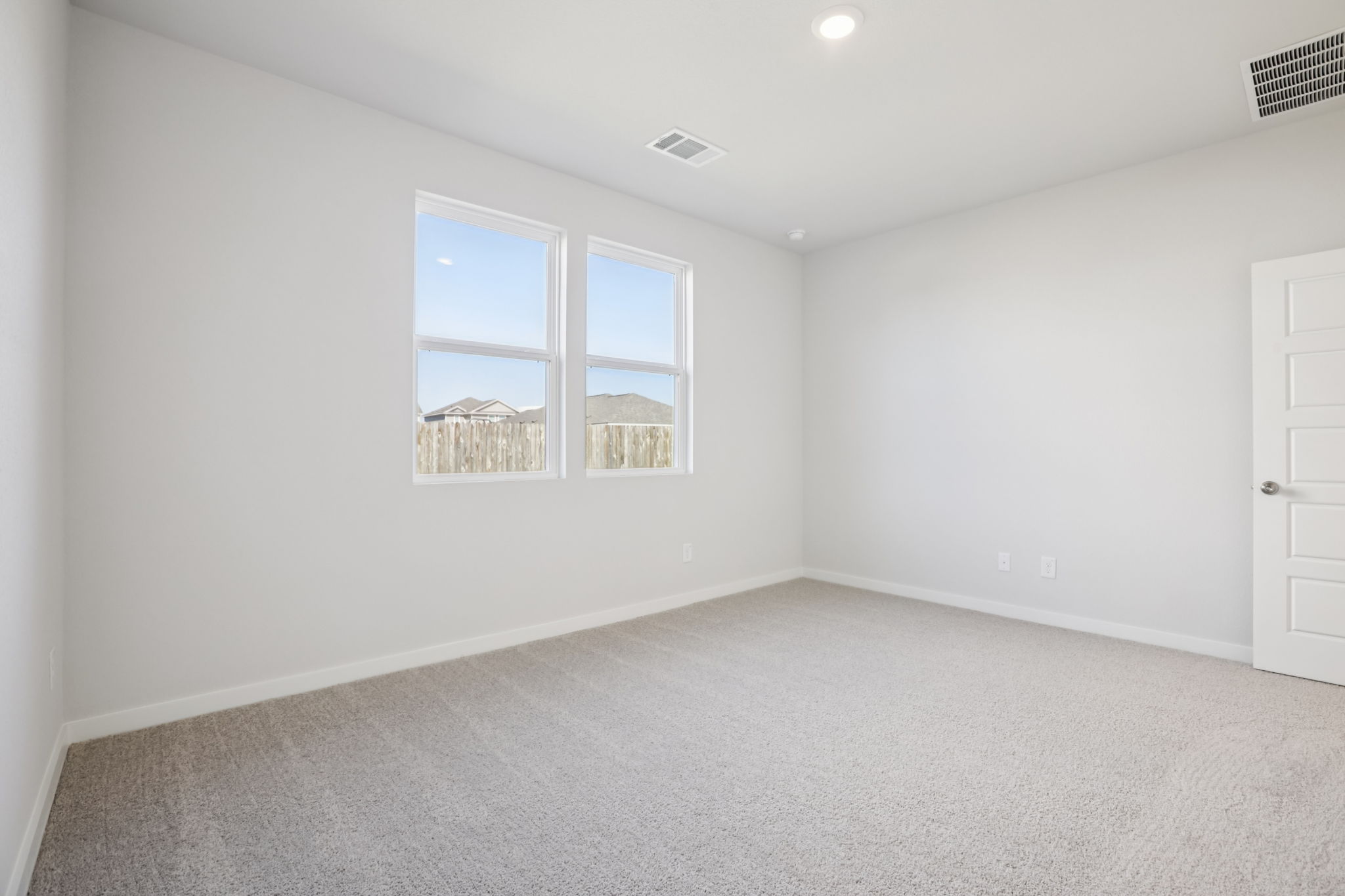 A room with a window and a door.