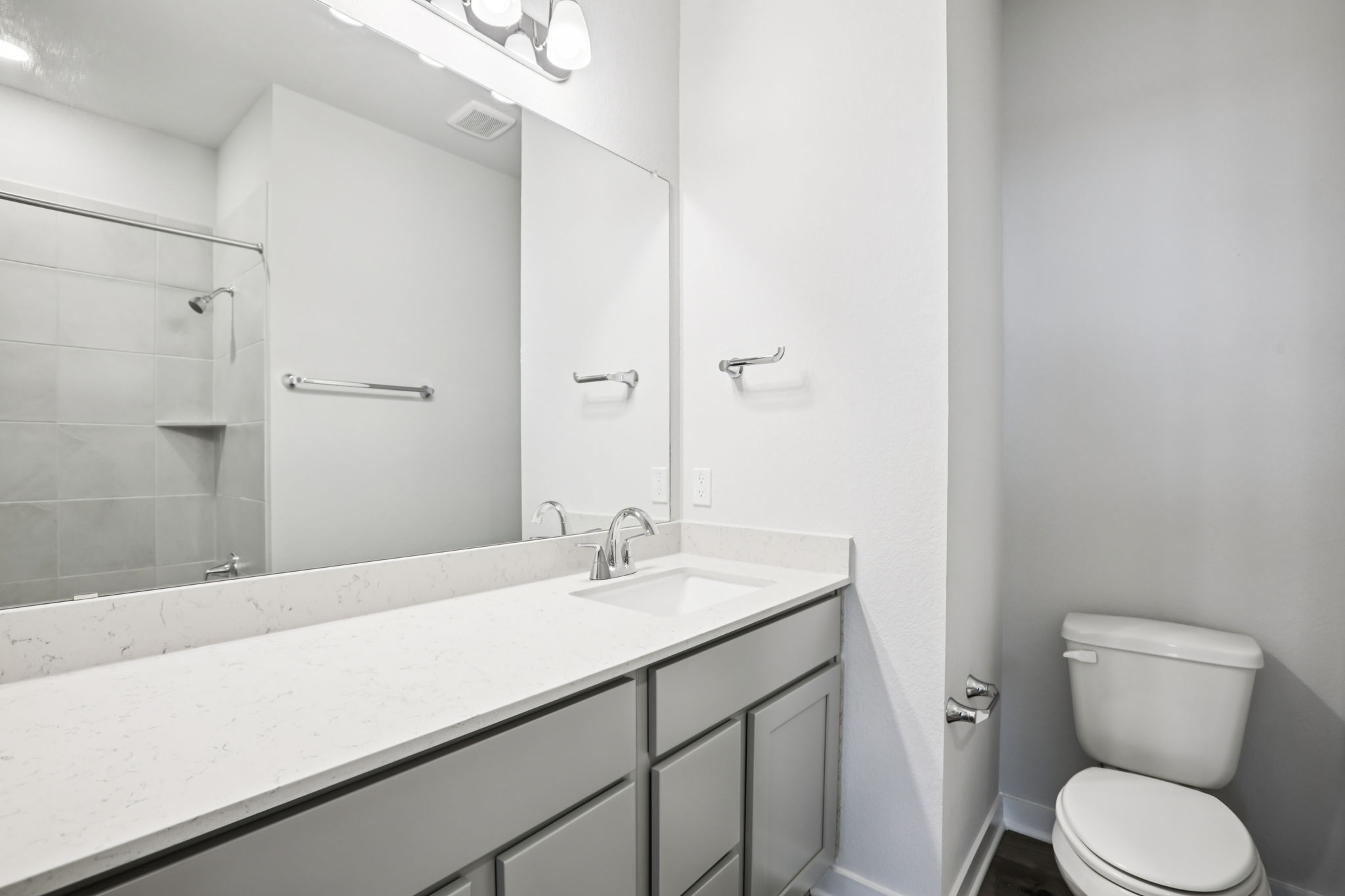 A bathroom with a sink toilet and shower.