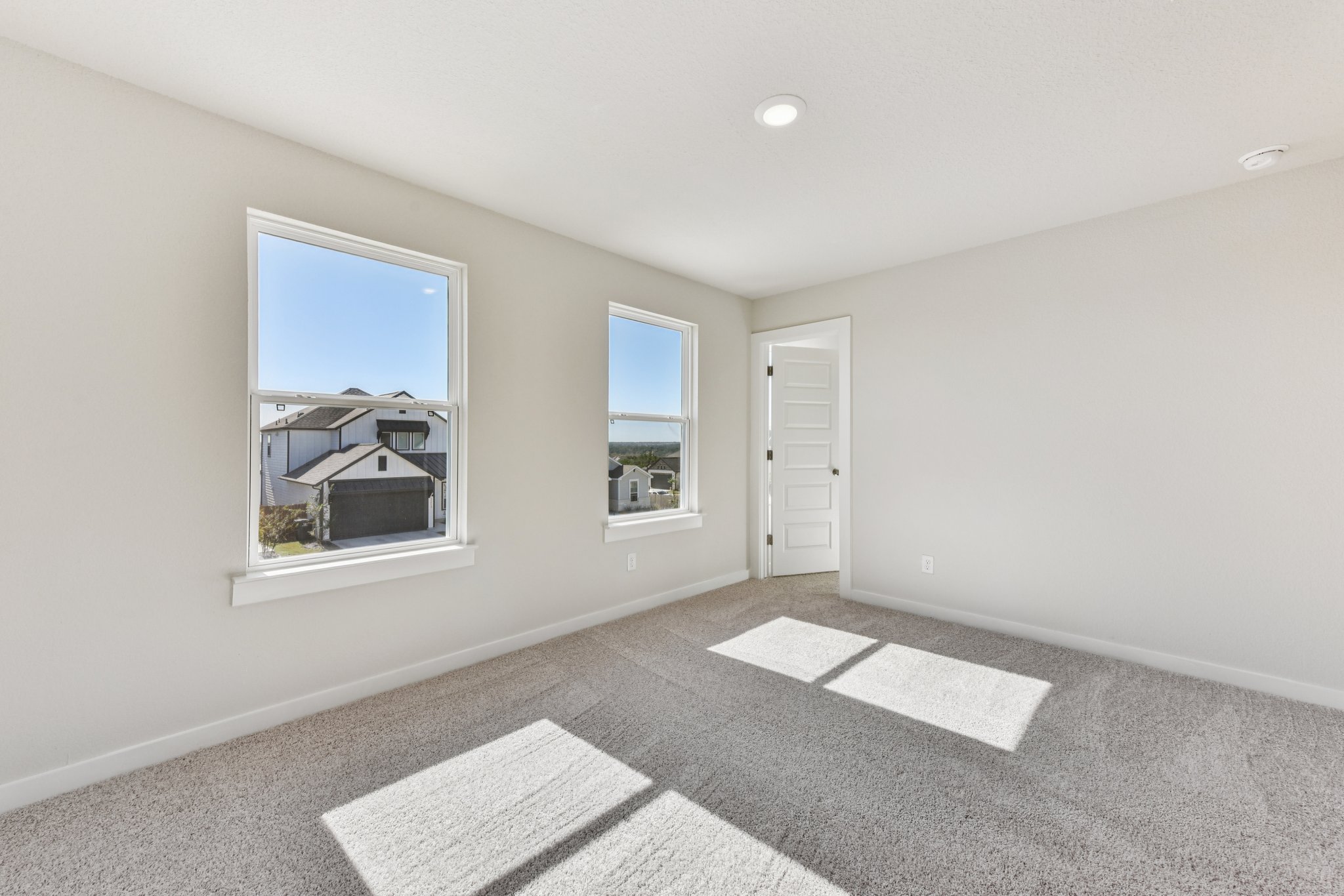 A room with a window and a rug.
