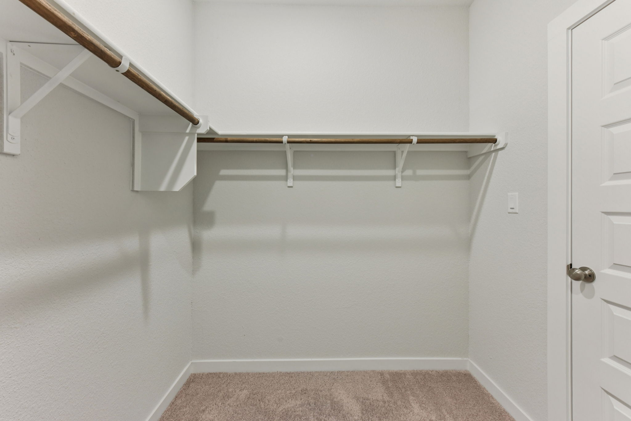 A white room with a staircase.