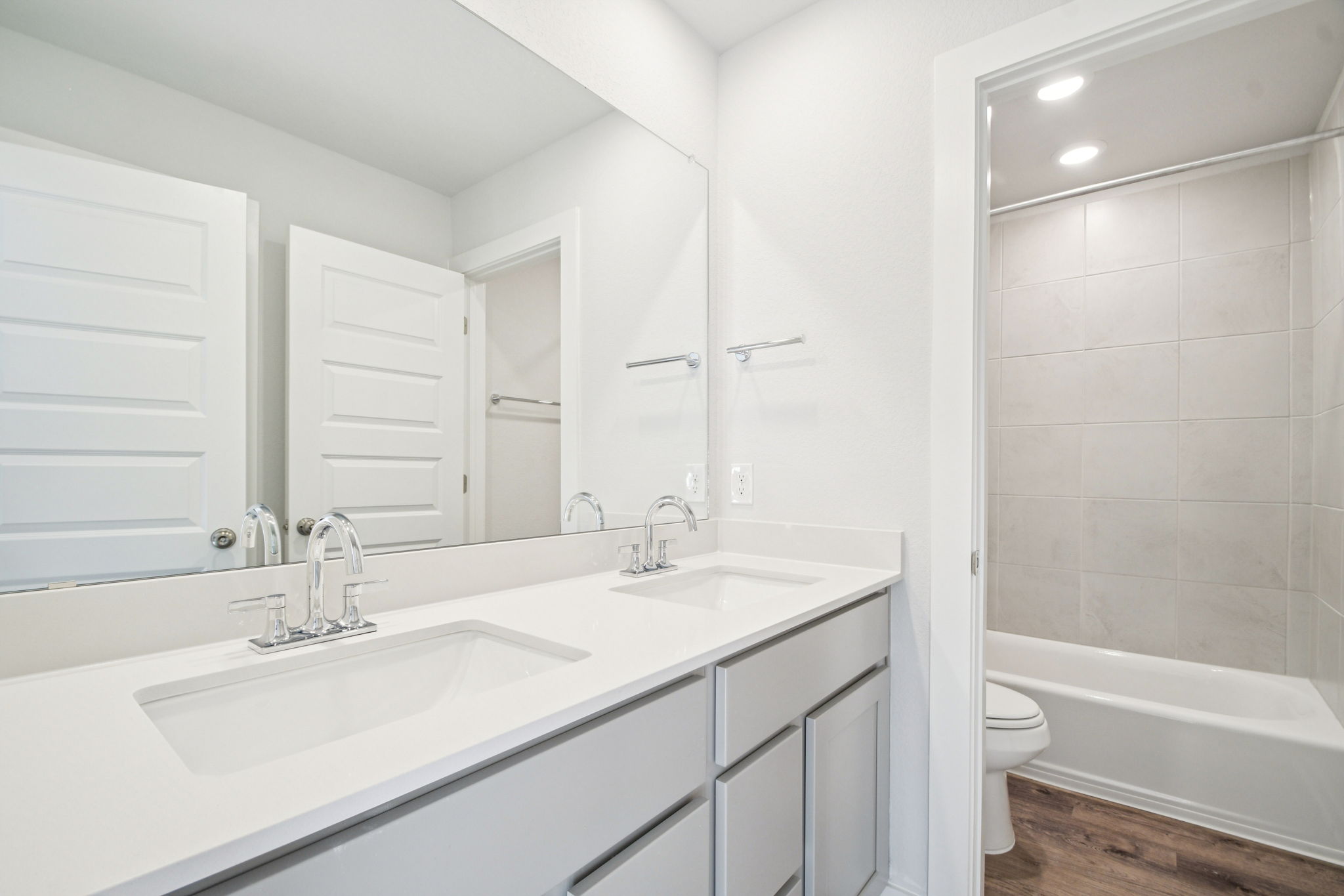 A bathroom with a tub sink and toilet.
