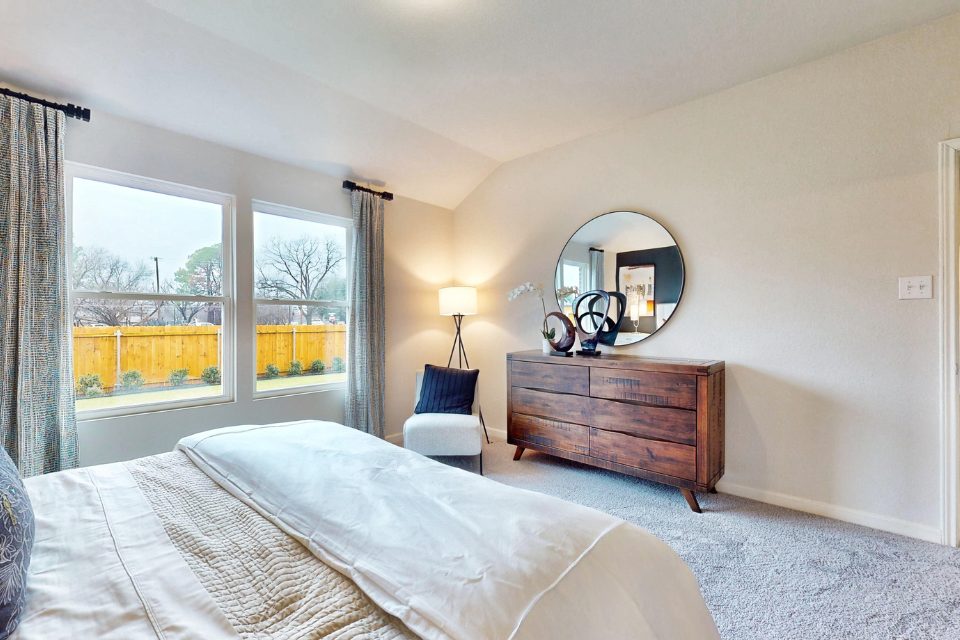A bedroom with a large window.