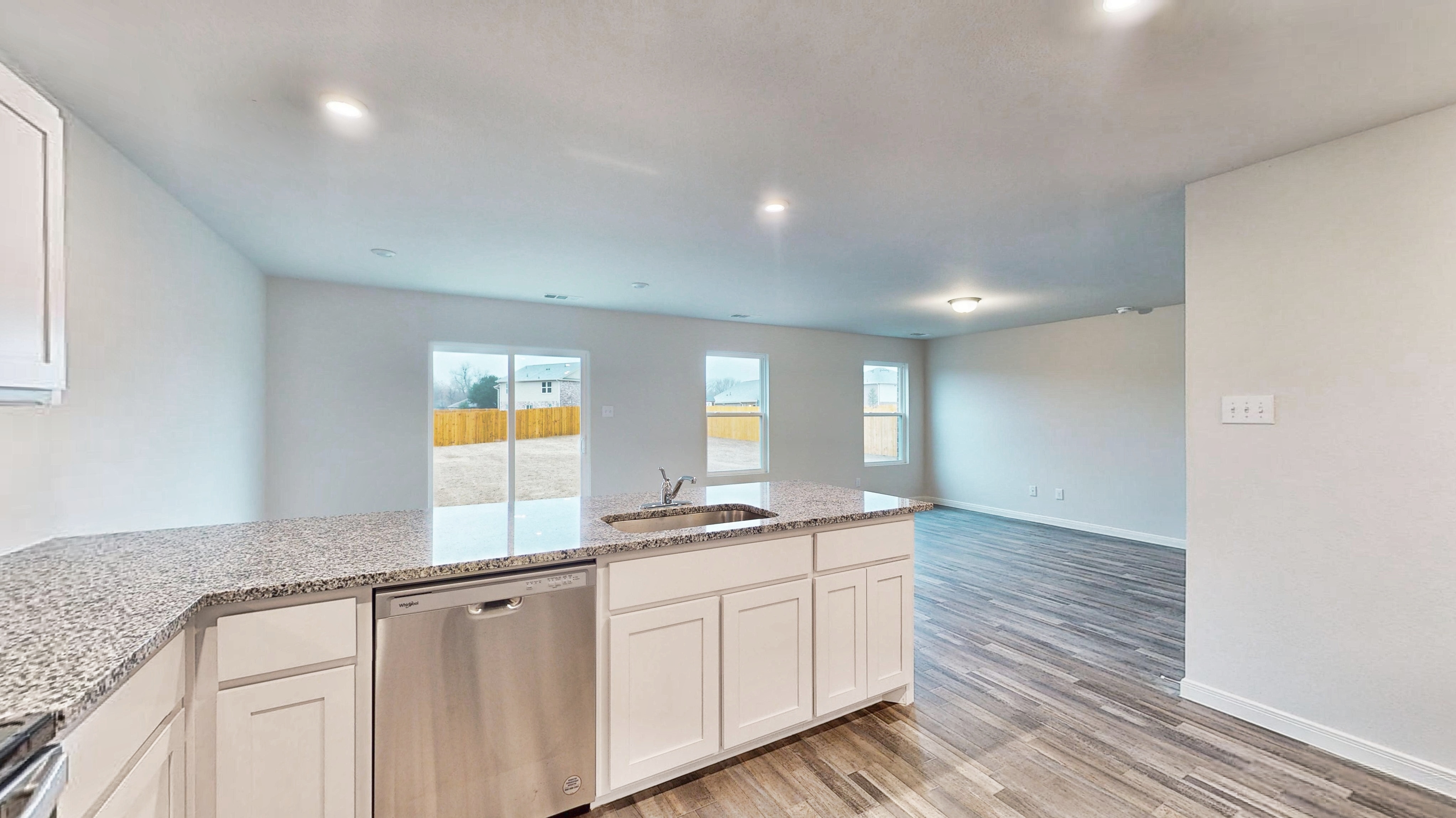 A kitchen with white cabinets.