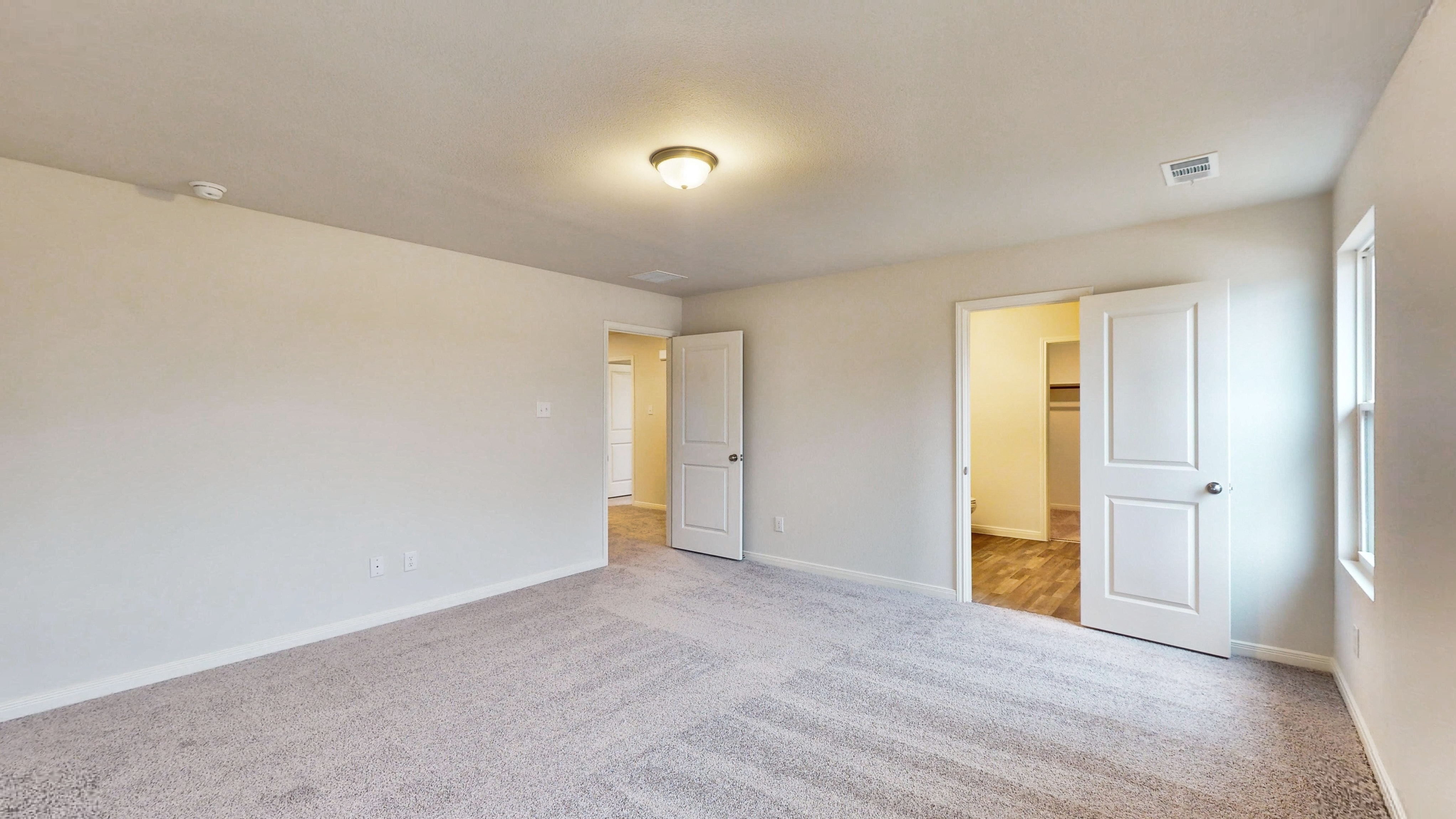 A hallway with white doors.