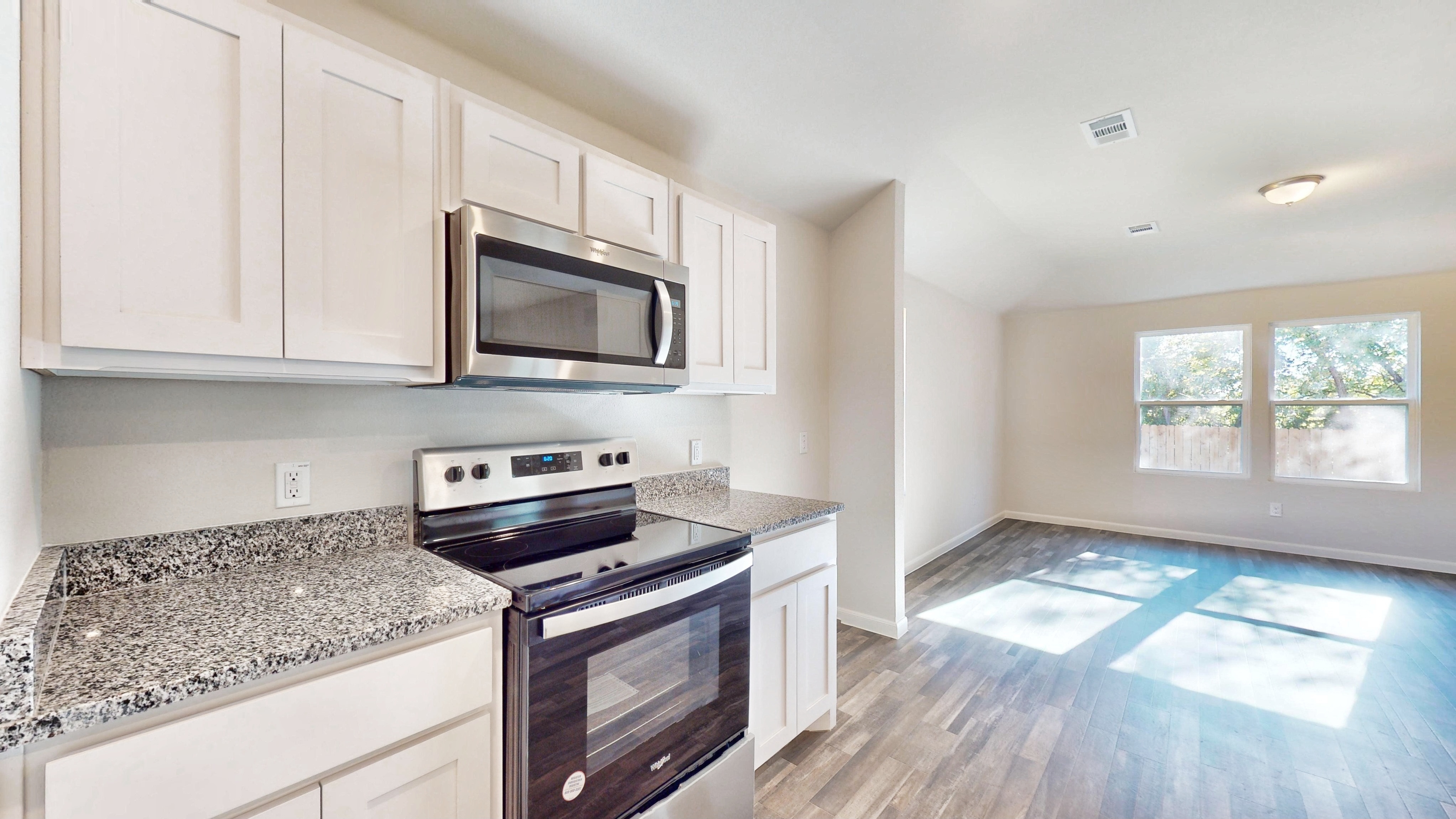 A kitchen with white cabinets.