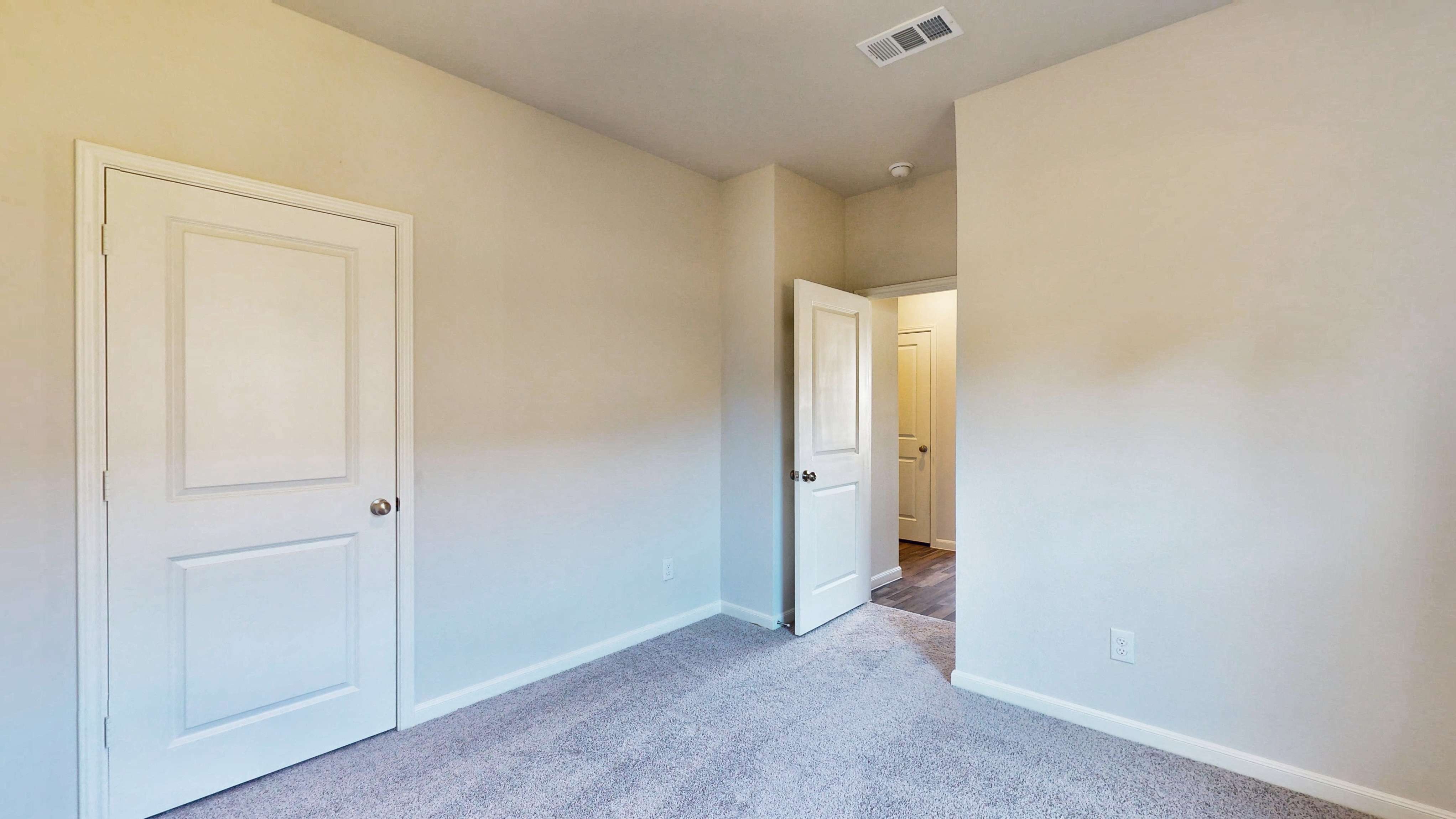 A hallway with white doors.