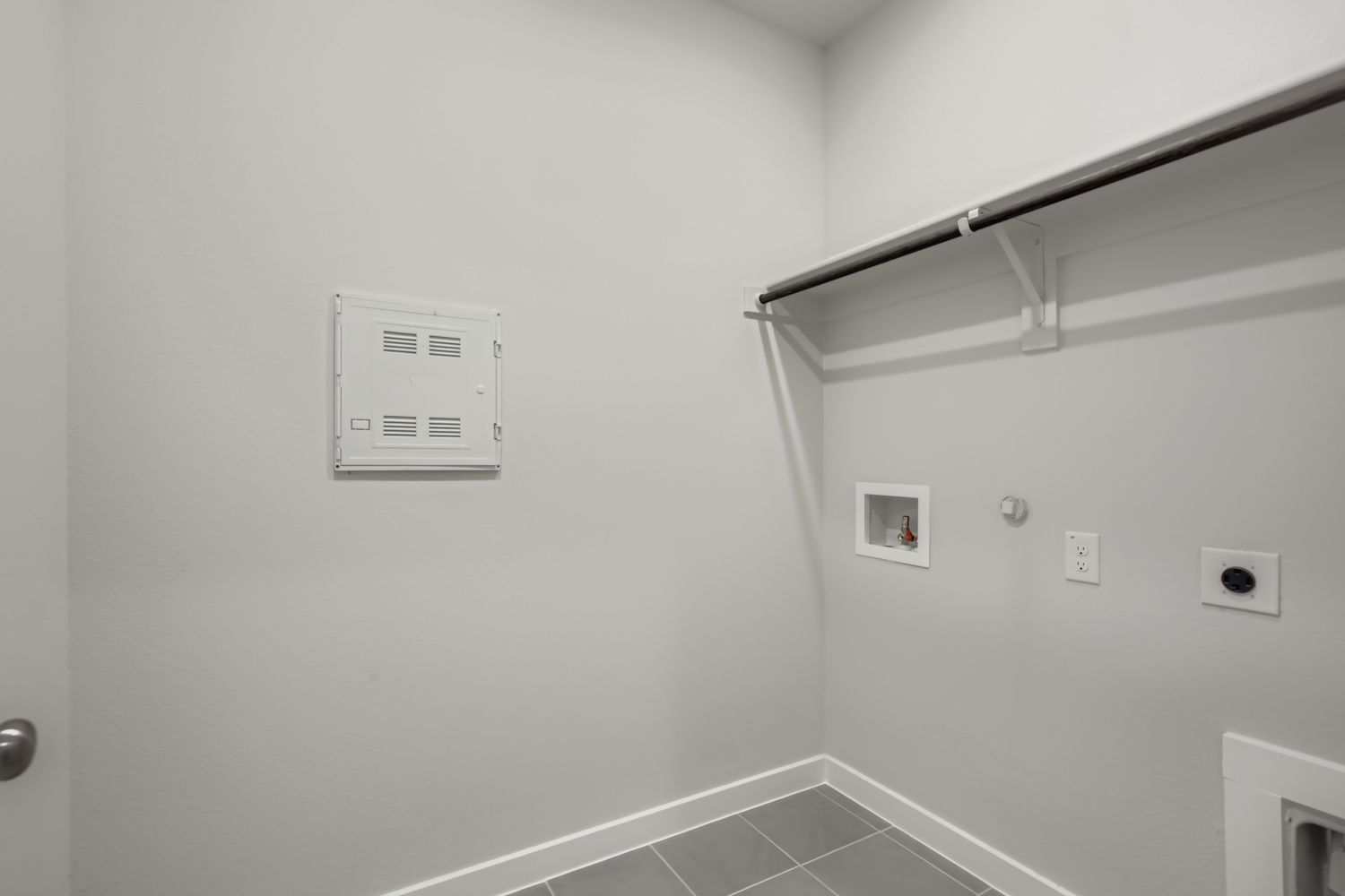 A white wall with a light fixture.