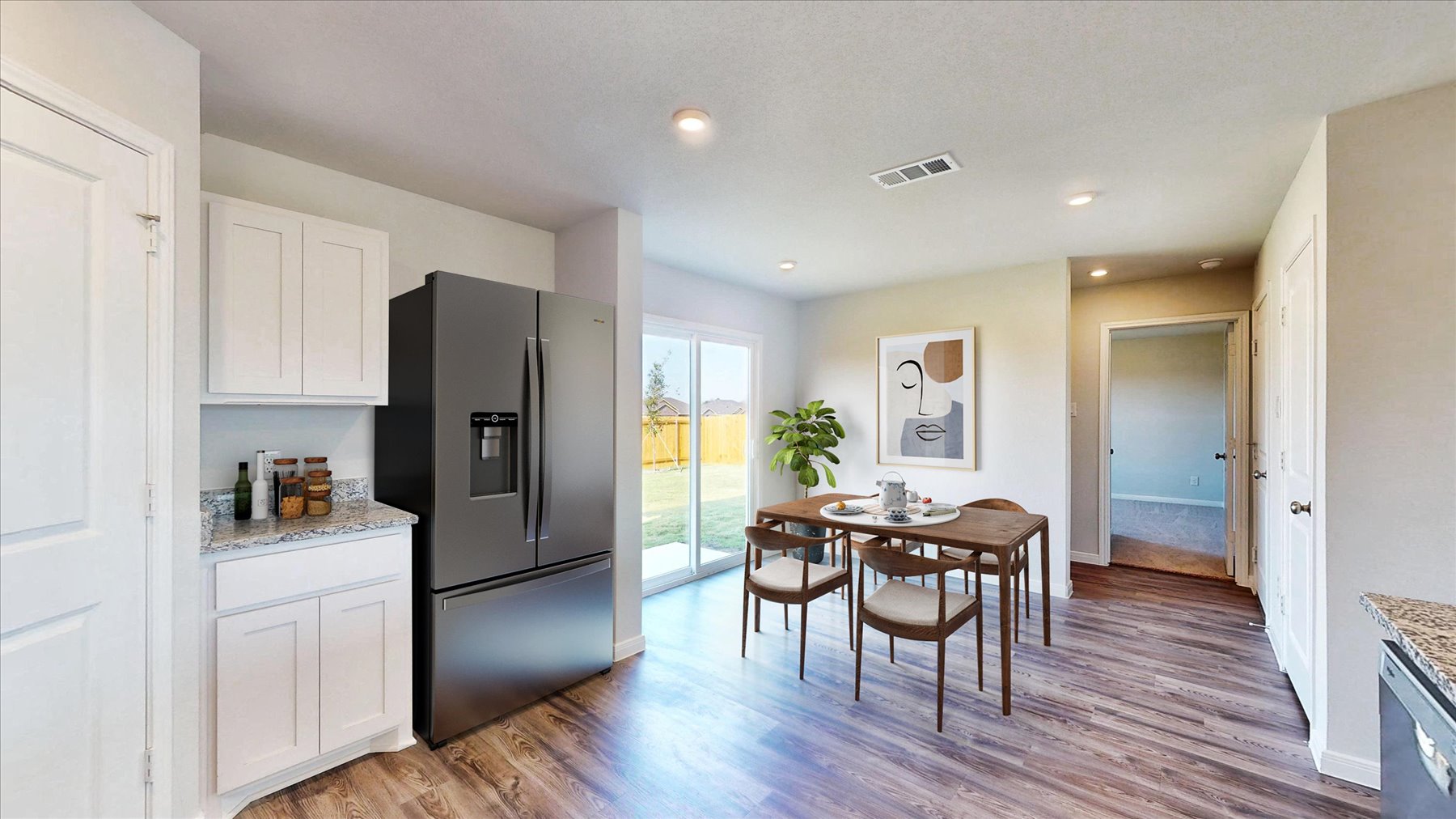 A kitchen with a table and chairs.