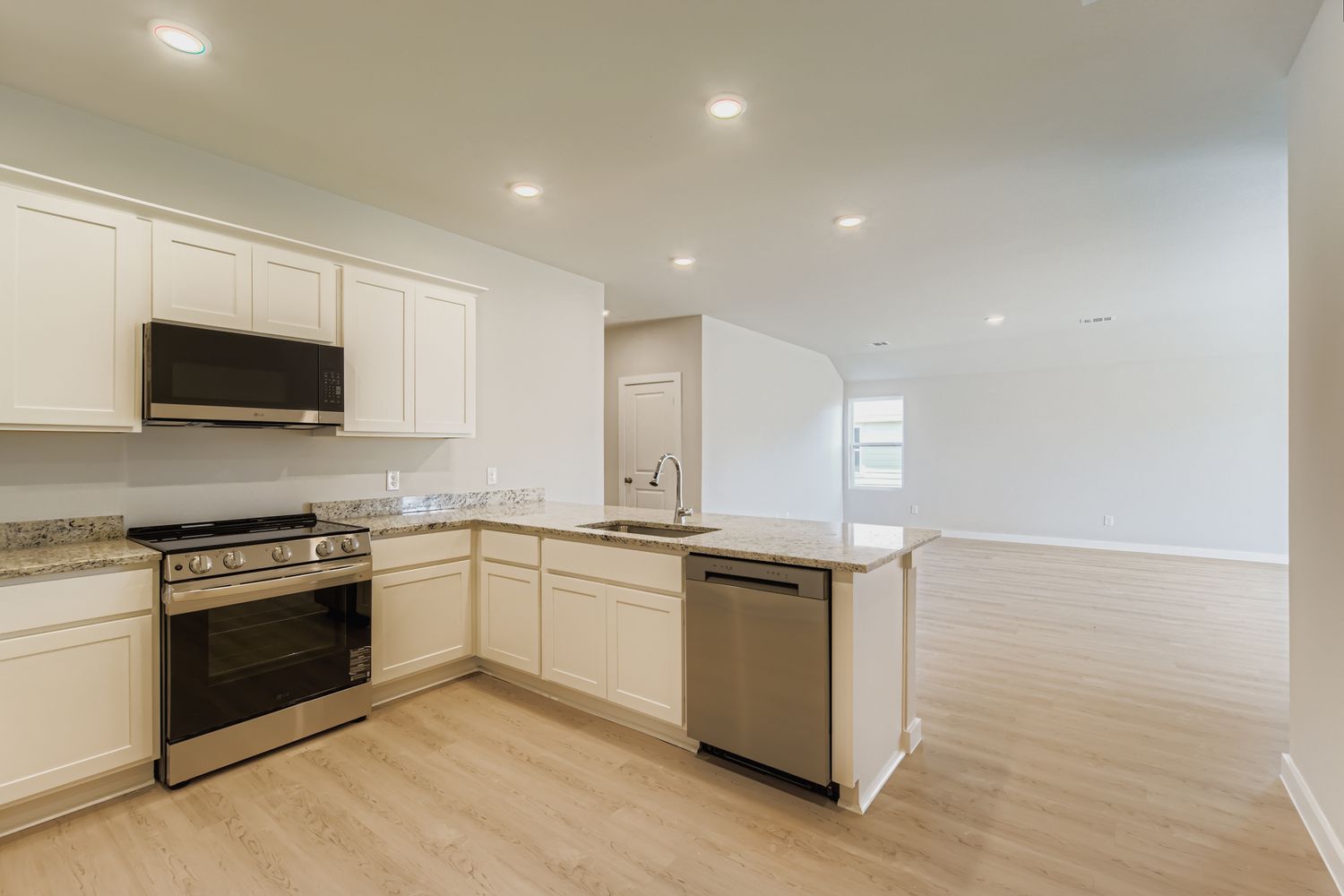 A kitchen with white cabinets.