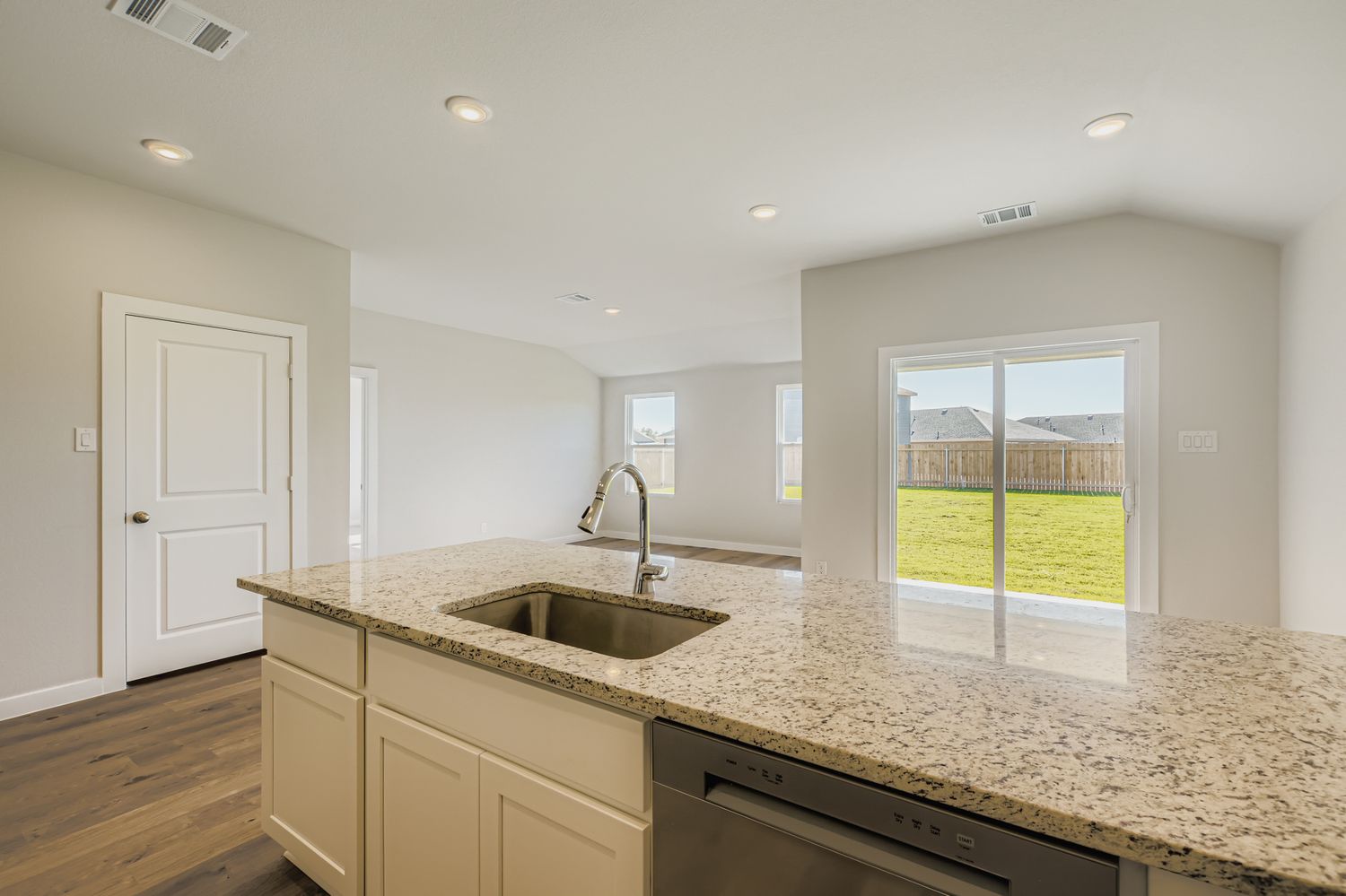 A kitchen with a large window.