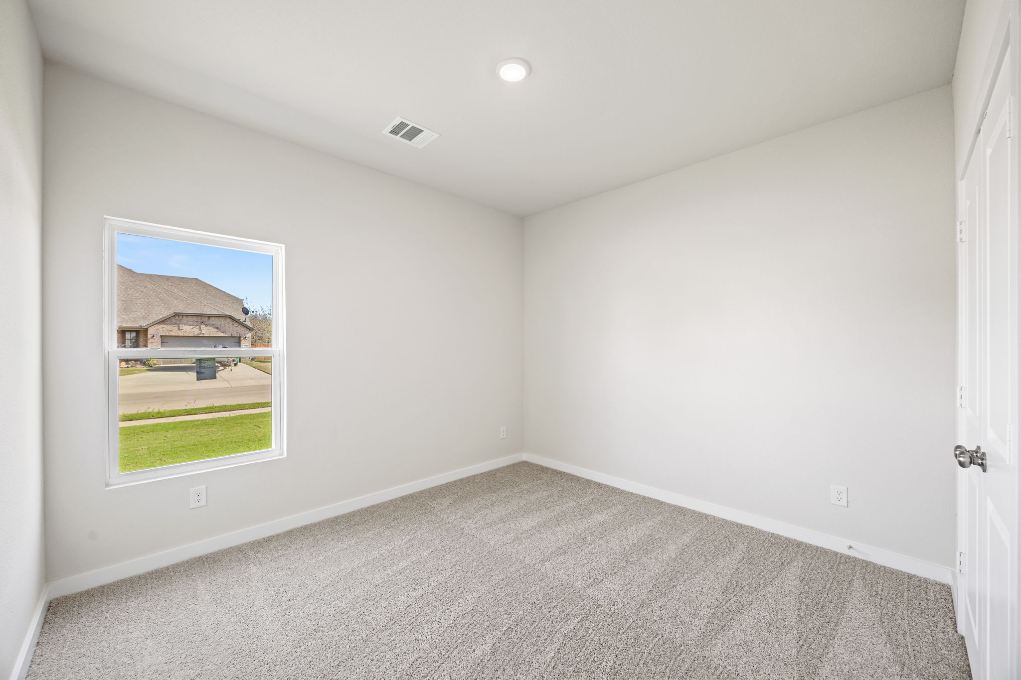 A room with a window and a door.