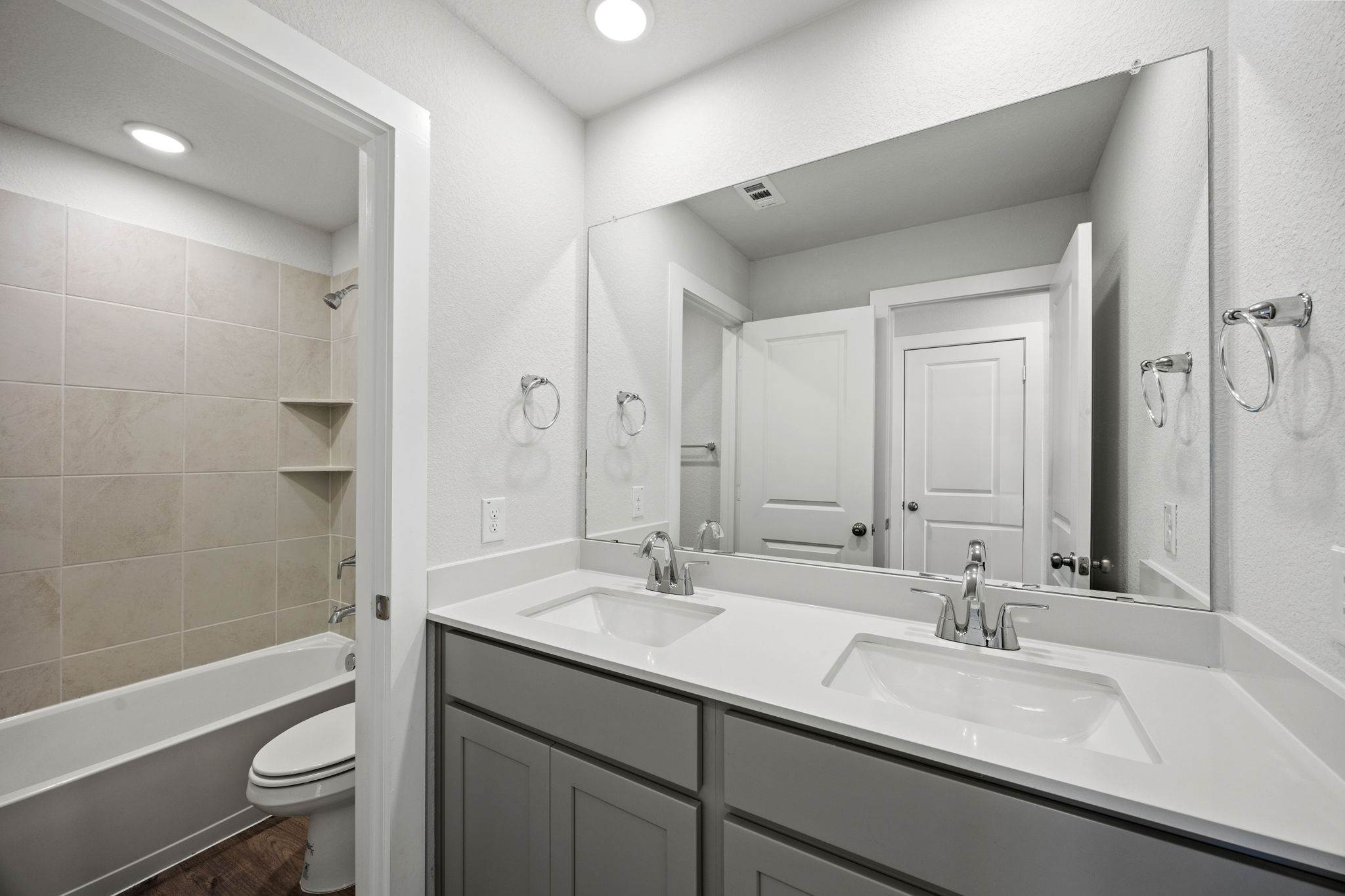 A bathroom with a tub sink and toilet.