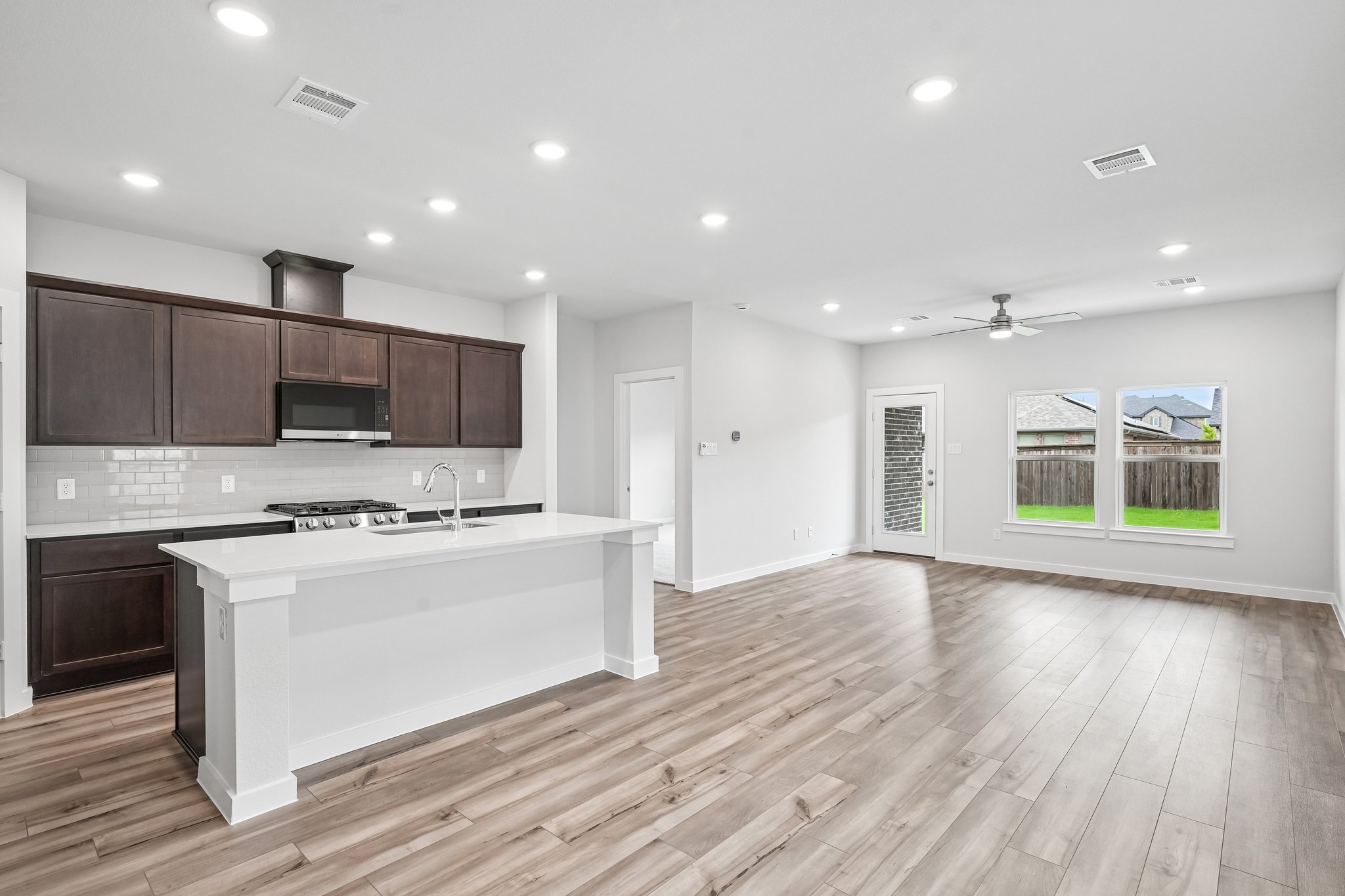 A kitchen with a wood floor.