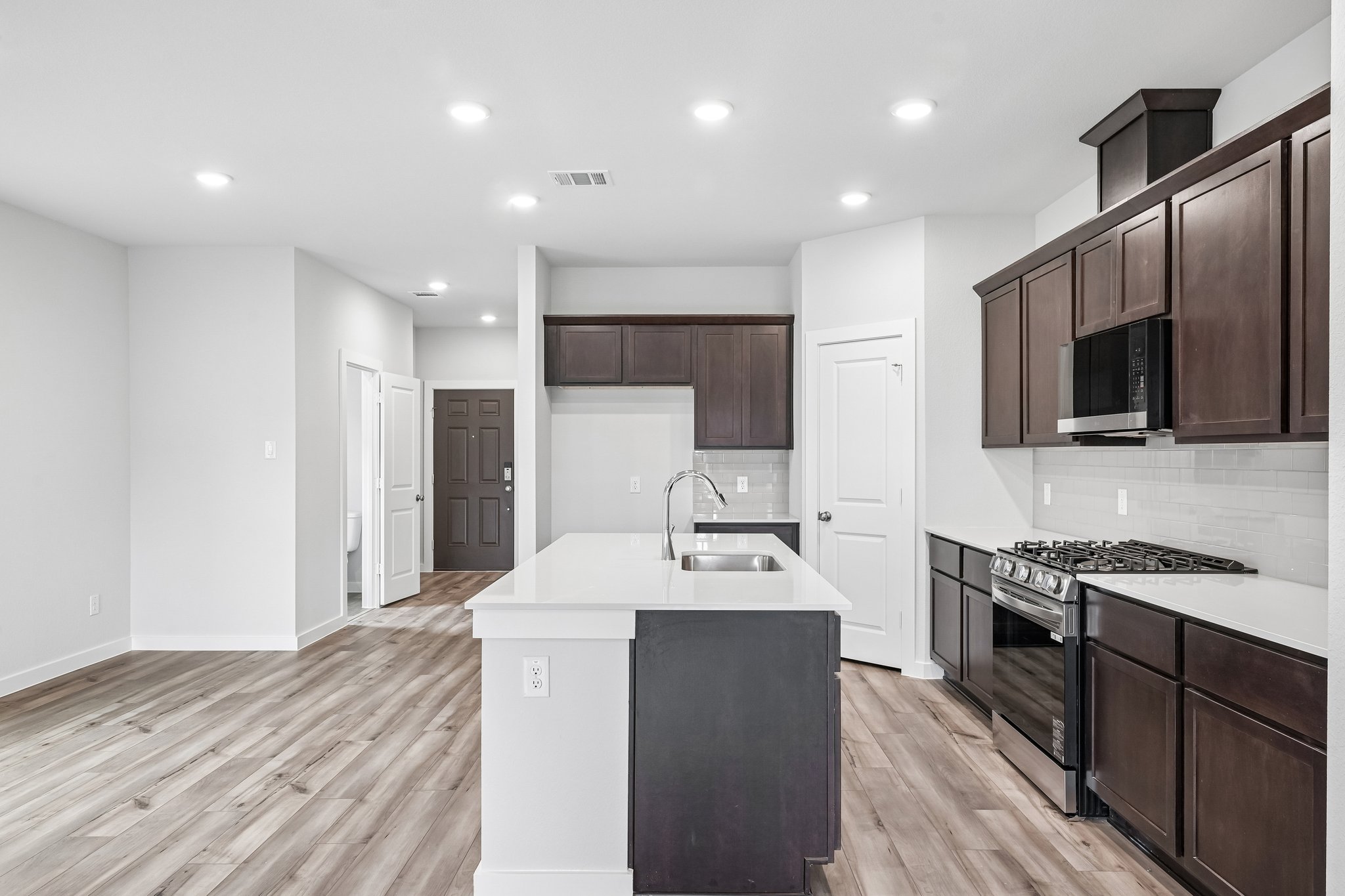 A kitchen with black cabinets.