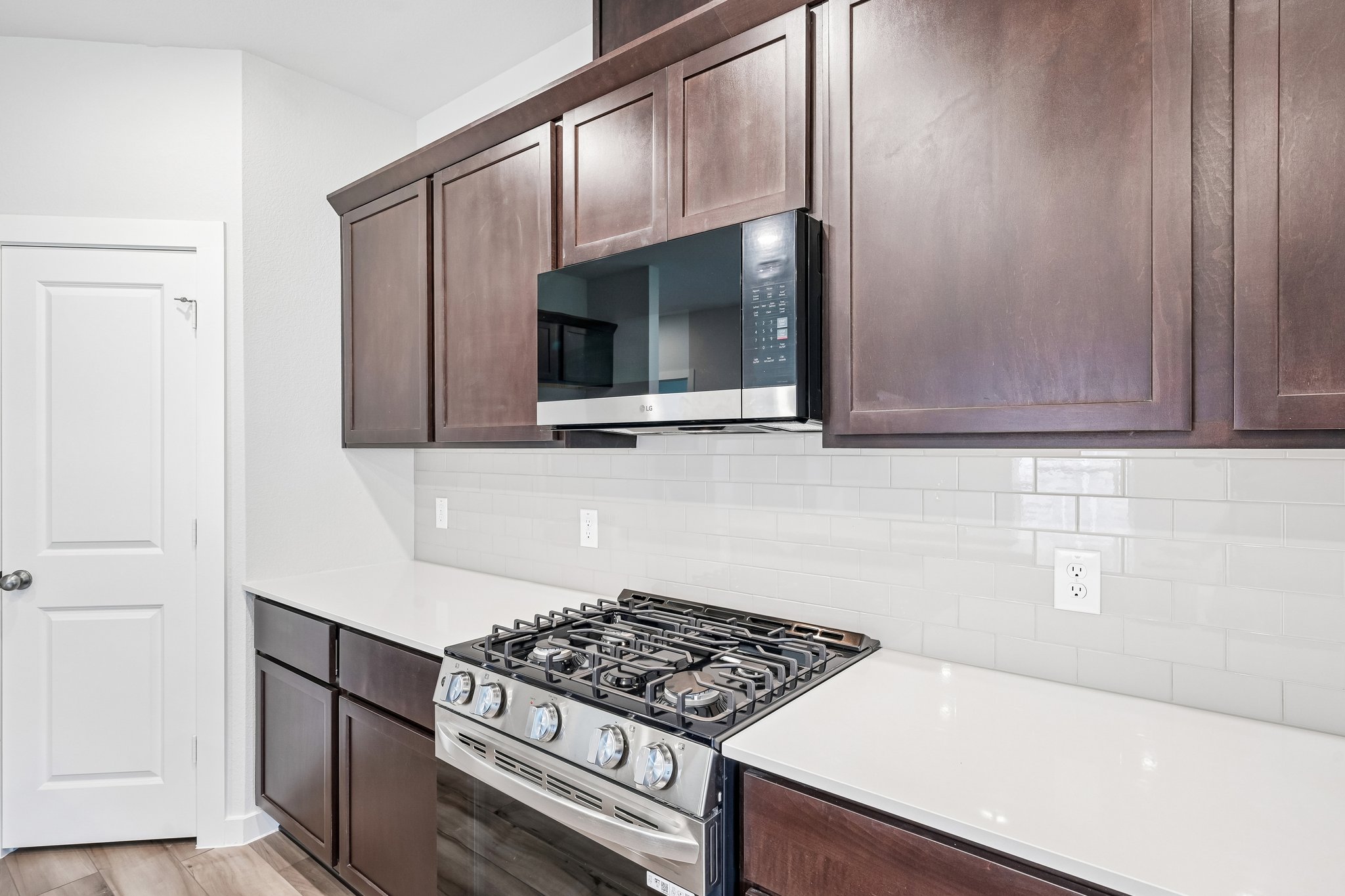 A kitchen with wooden cabinets.