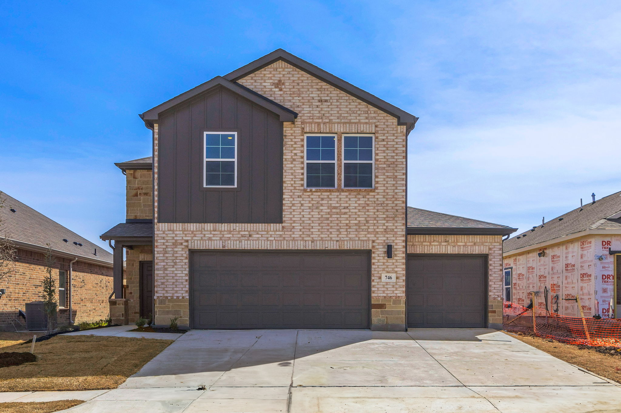 A brick building with a garage.