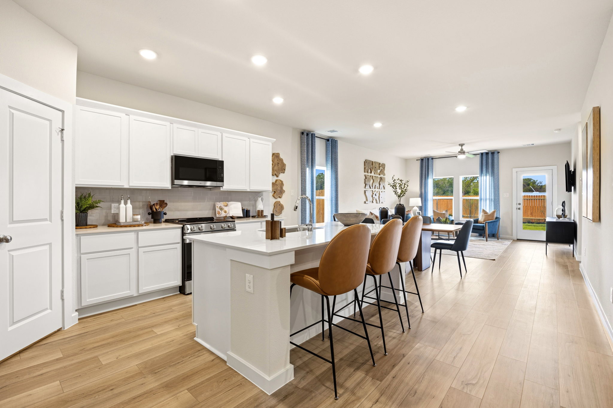 A kitchen with white cabinets.