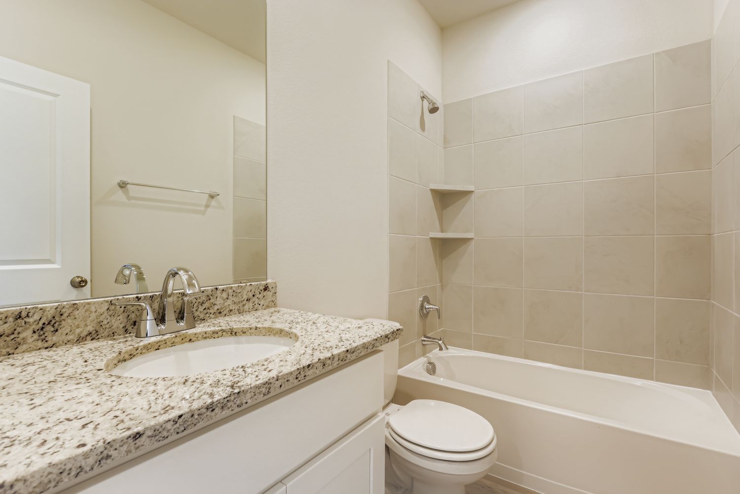 A bathroom with a marble countertop.