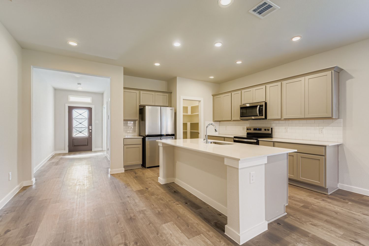 A kitchen with white cabinets.