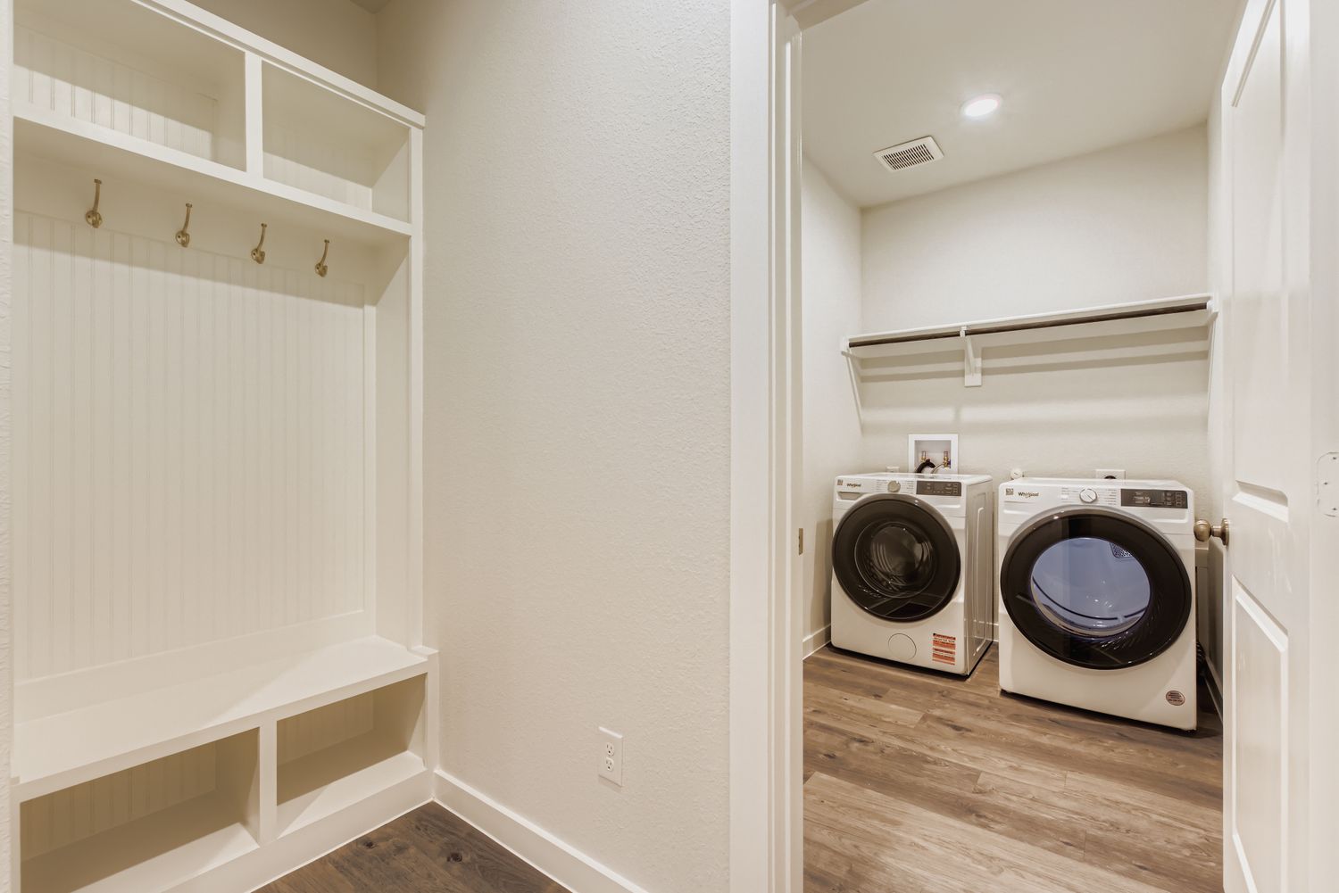 A room with white walls and a washing machine.