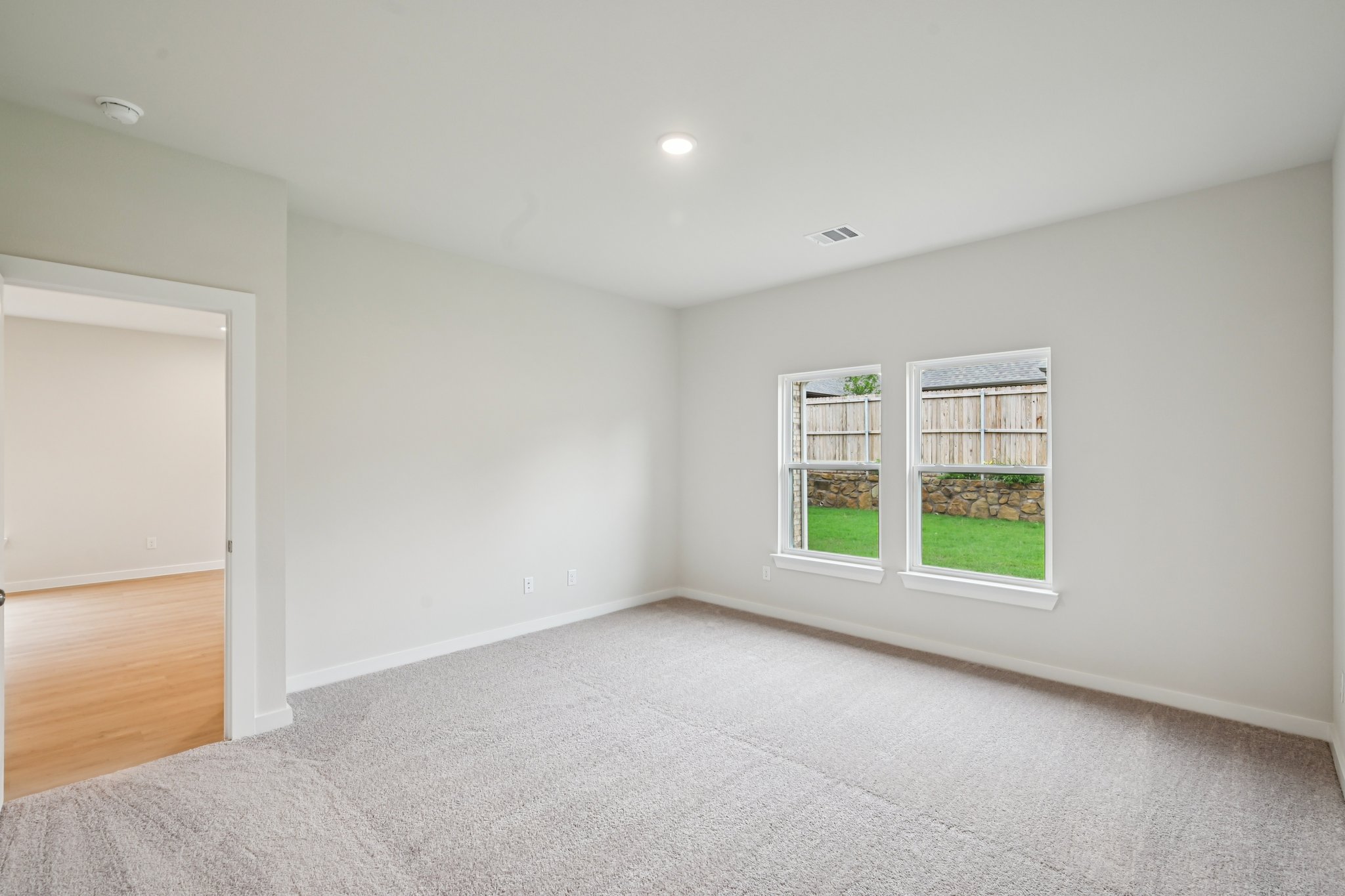 A room with a window and a door.