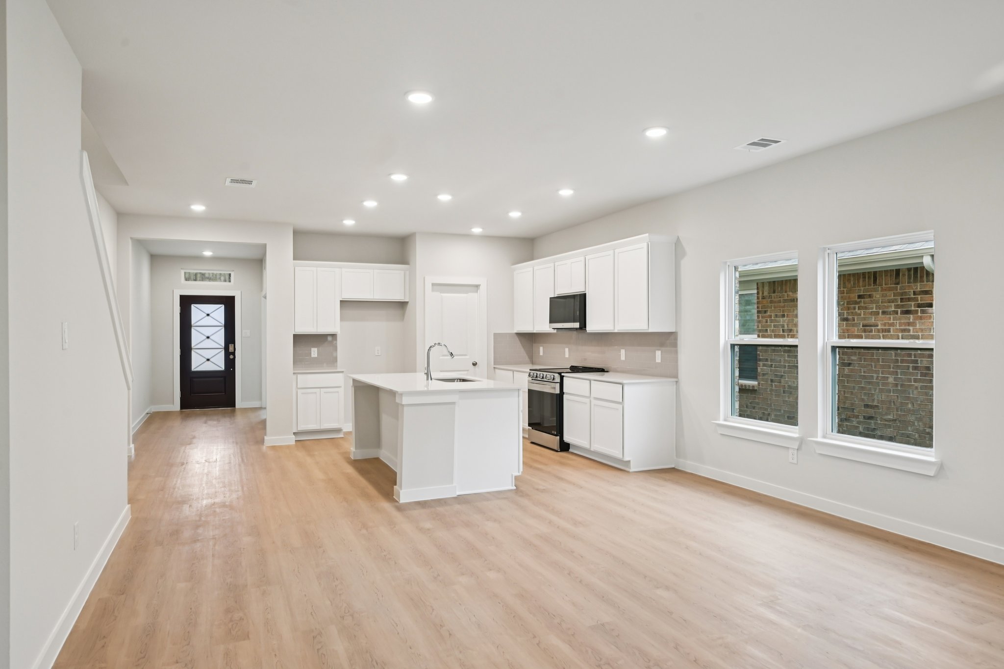 A kitchen with white cabinets.