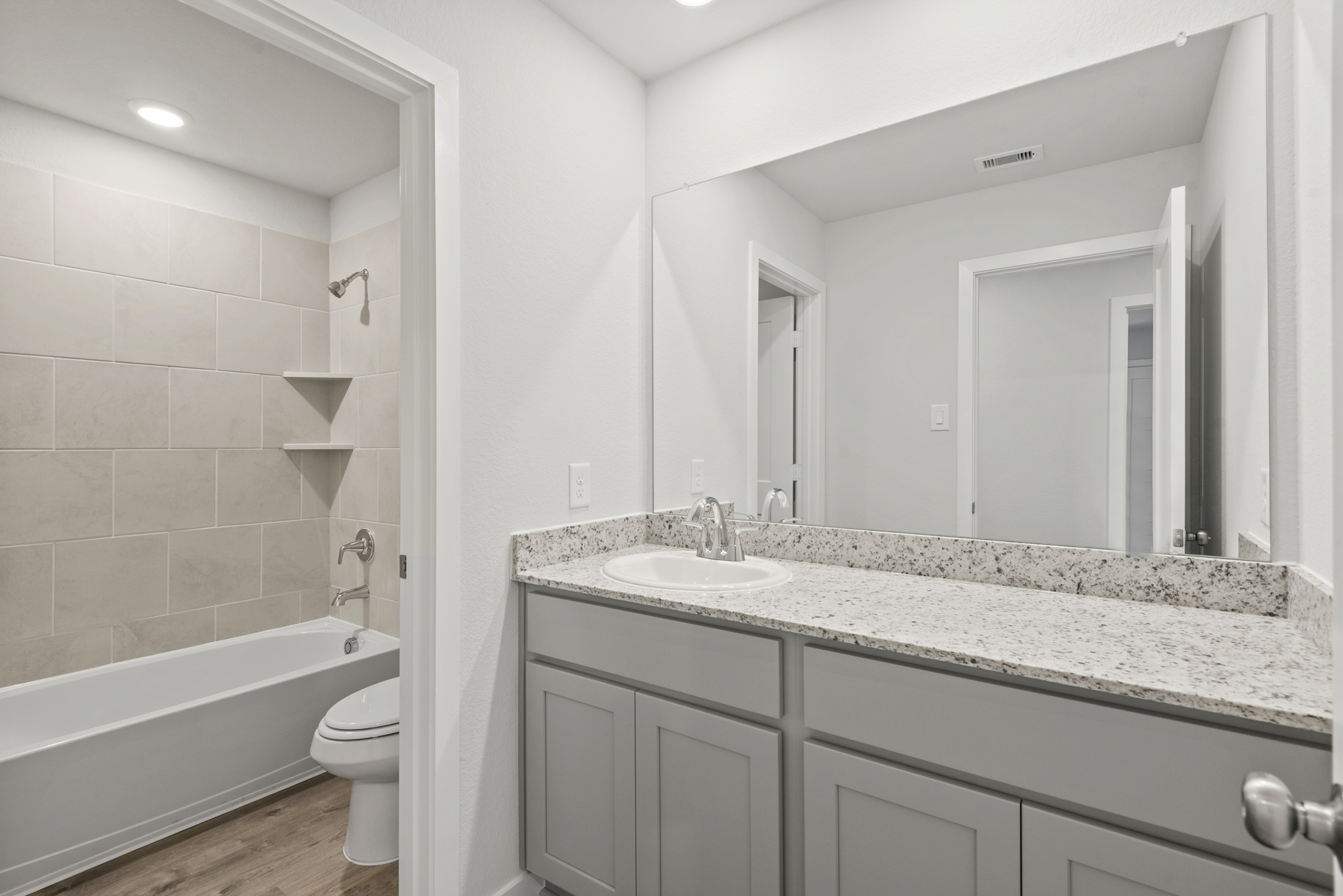 A bathroom with a marble countertop.